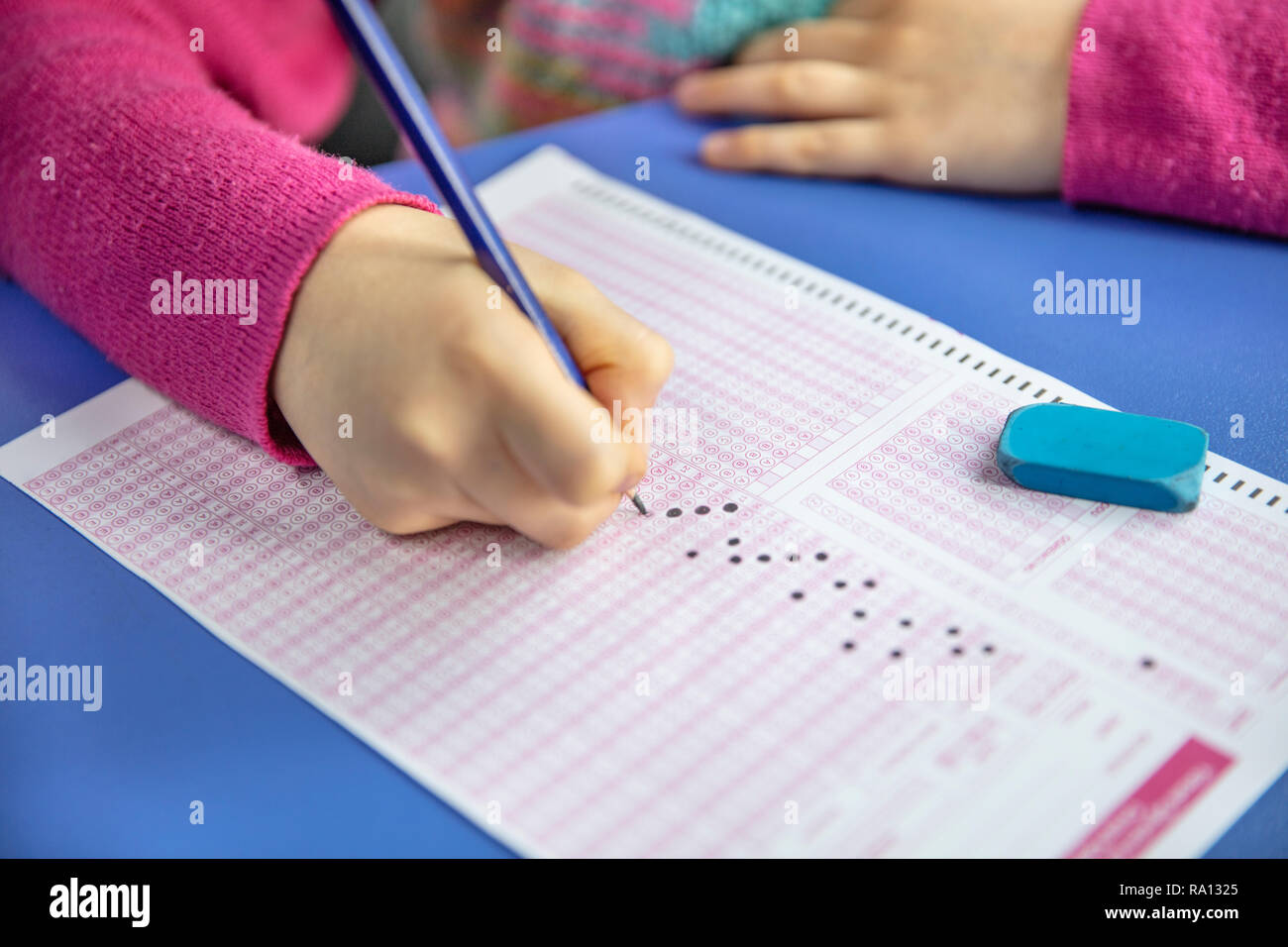 Pencil drawing selected choice on answer sheets. hand fill in Exam carbon paper computer sheet and pencil. Stock Photo