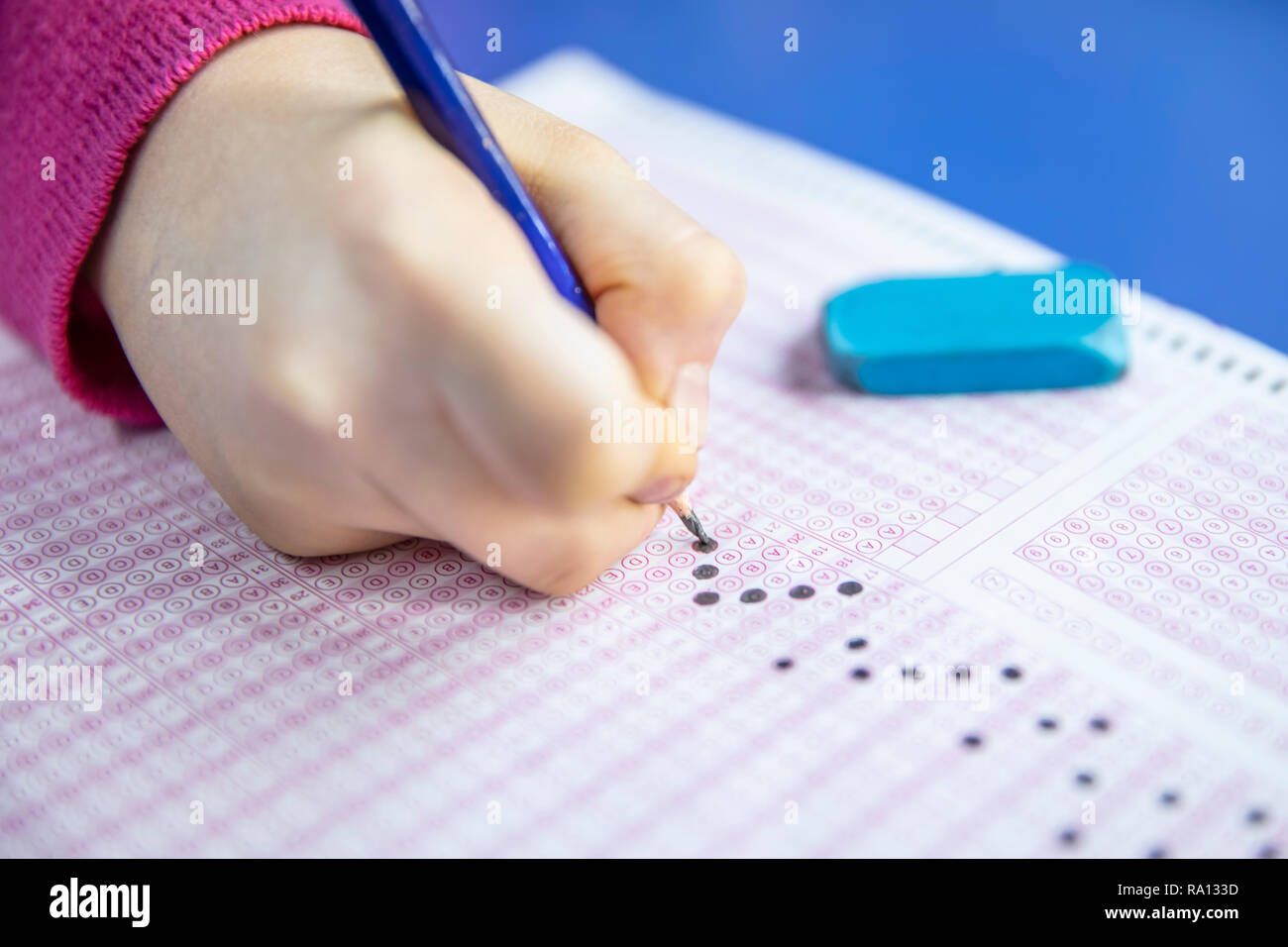 Pencil drawing selected choice on answer sheets. hand fill in Exam carbon paper computer sheet and pencil. Stock Photo