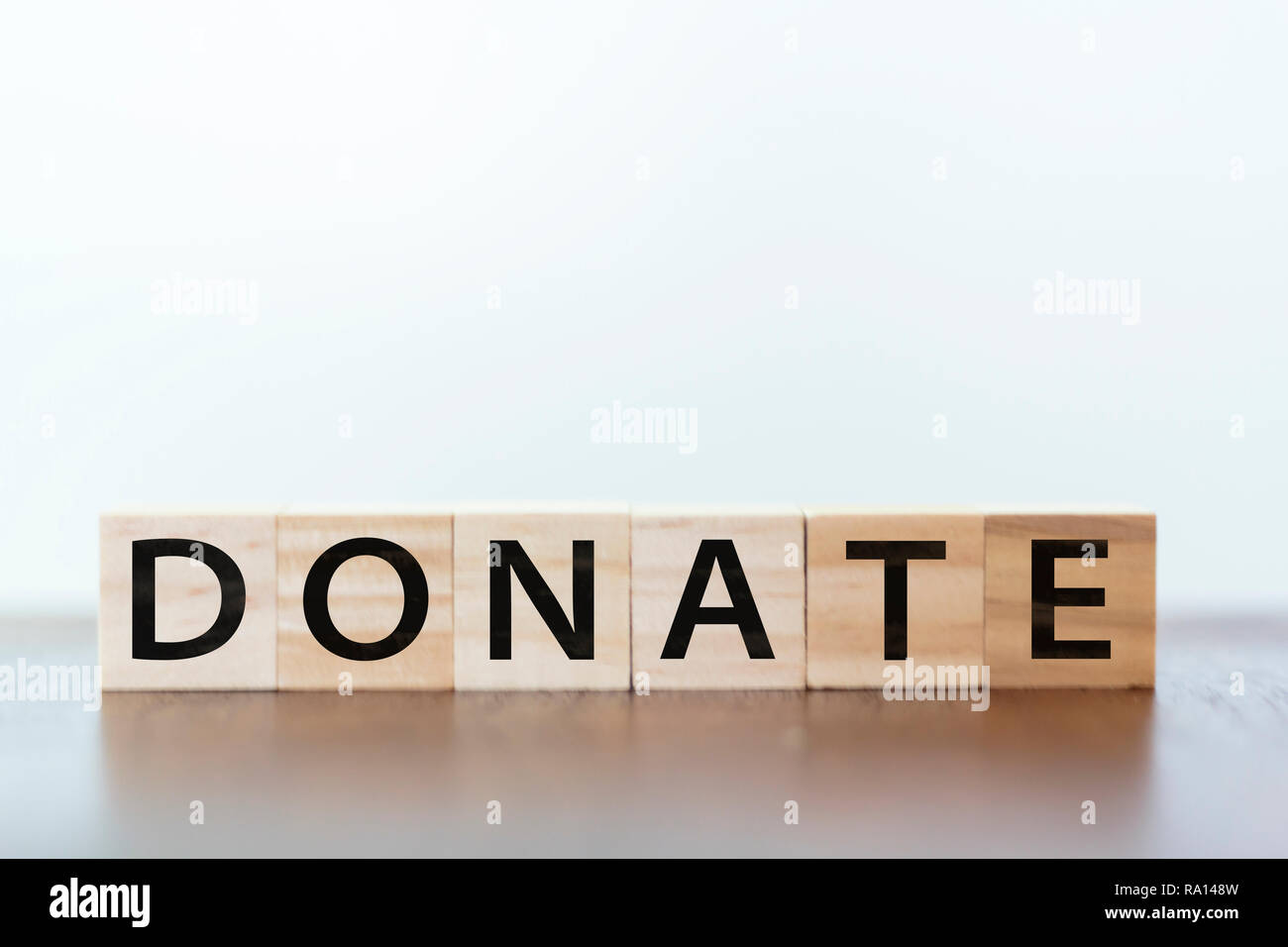 Please donate words written on white board Stock Photo - Alamy