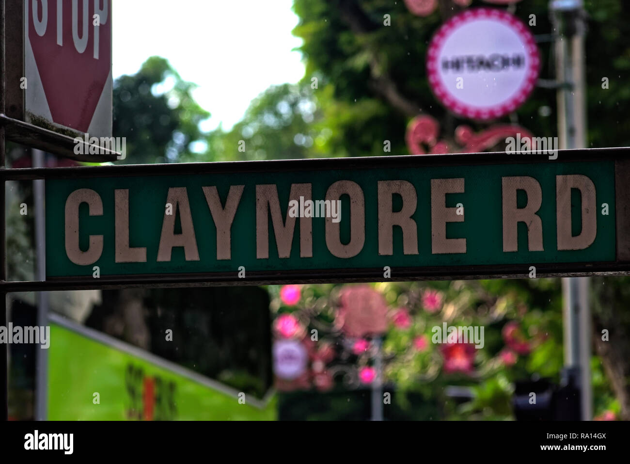 Street sign for Claymore Road, Singapore with stop sign at road junction behind Stock Photo