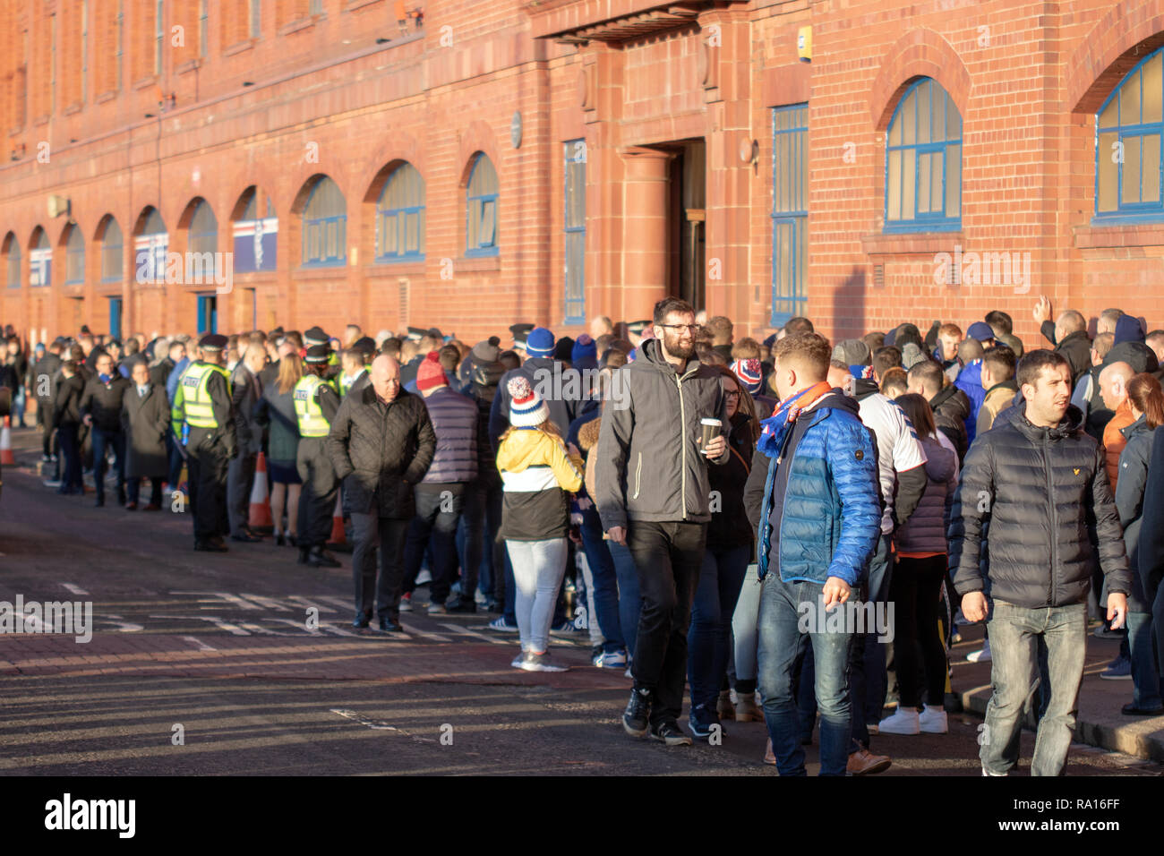 Glasgow, Scotland, UK. 29th December, 2018. Rangers have won 1-0 at full-time, at home at Ibrox Stadium, with a goal scored by Jack (30 minutes). Earlier, despite a massive police presence, smoke bombs were thrown during the arrival of the Celtic team bus. Amidst rising tensions, fans were being kept apart prior to kick-off at 12:30, as well as after the match. Police officers were seen filming the crowds outside the ground. Iain McGuinness / Alamy Live News Stock Photo