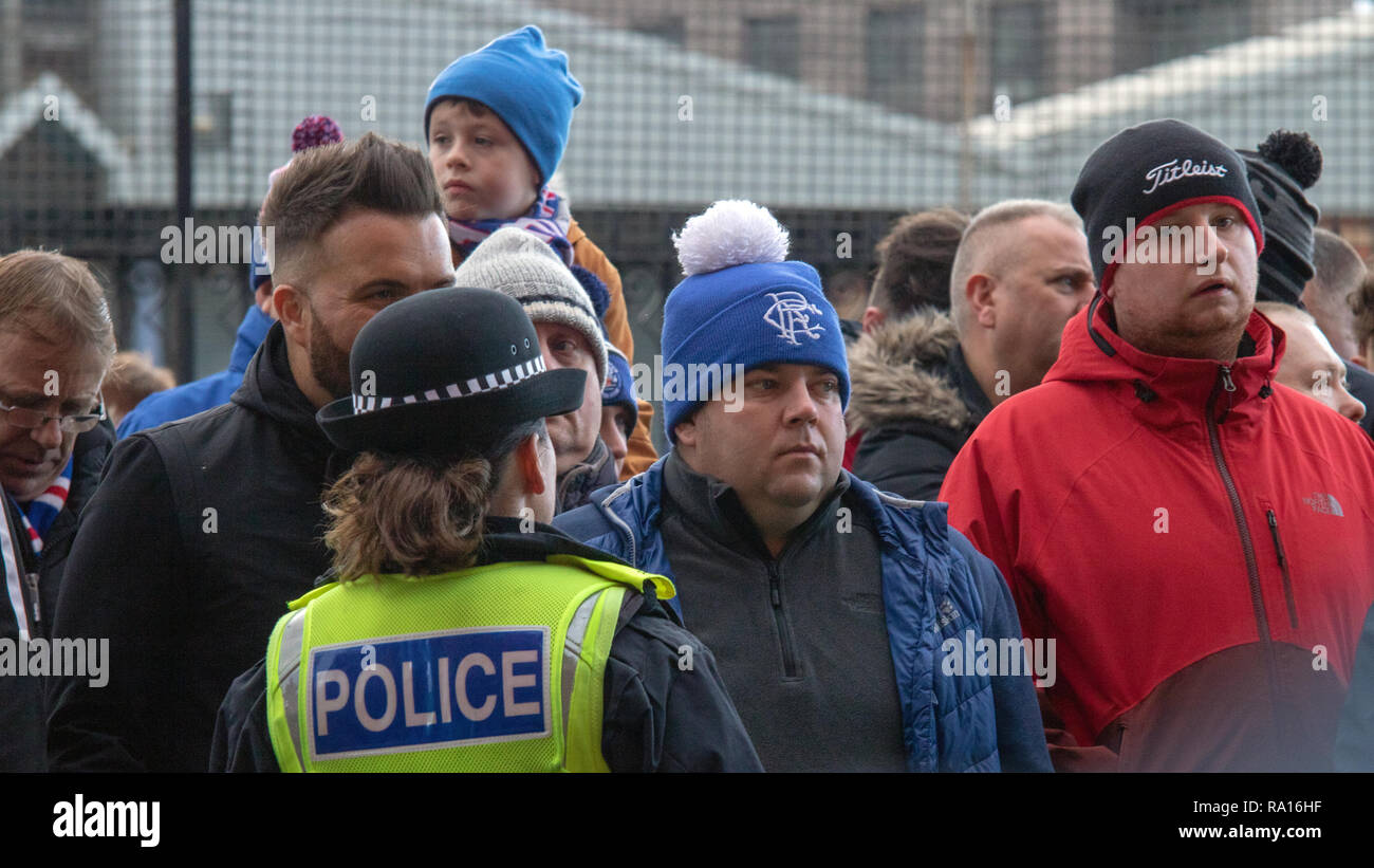 Glasgow, Scotland, UK. 29th December, 2018. Rangers have won 1-0 at full-time, at home at Ibrox Stadium, with a goal scored by Jack (30 minutes). Earlier, despite a massive police presence, smoke bombs were thrown during the arrival of the Celtic team bus. Amidst rising tensions, fans were being kept apart prior to kick-off at 12:30, as well as after the match. Police officers were seen filming the crowds outside the ground. Iain McGuinness / Alamy Live News Stock Photo