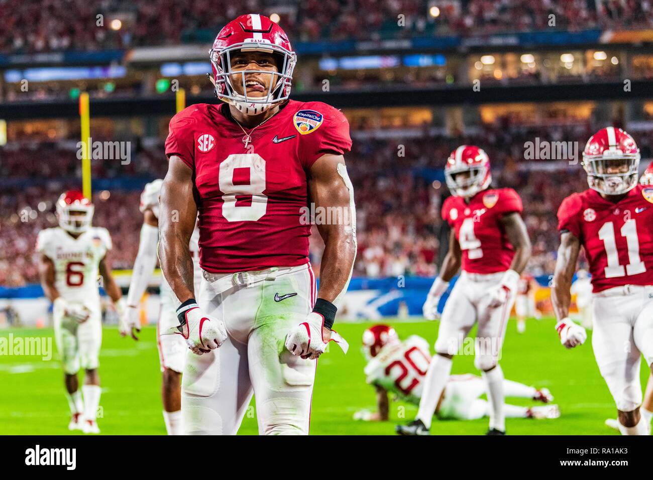 Alabama Crimson Tide quarterback Tua Tagovailoa (13) hands off to Alabama  Crimson Tide running back Josh Jacobs (8) in the fourth quarter during the  college football playoff semifinal at the Capital One