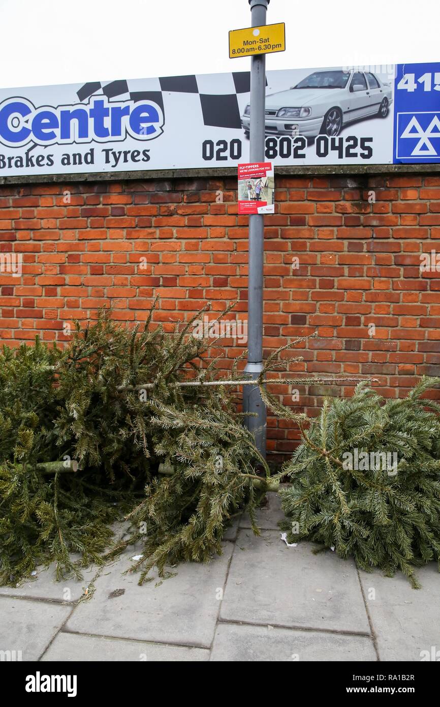 Christmas trees are seen on the pavement outside in North London just