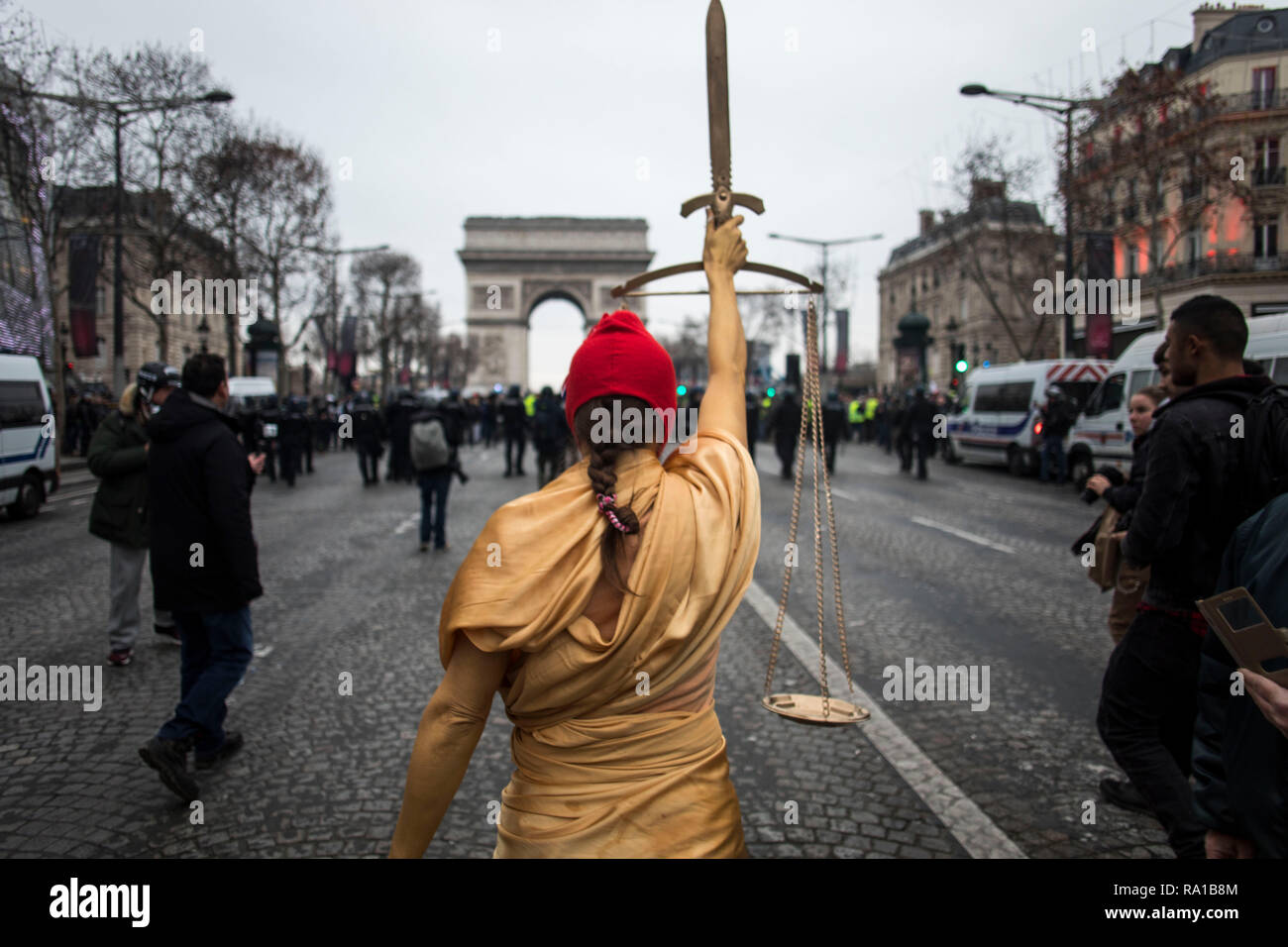 A woman dress as the French Republic national symbol 'La Marianne' seen at  the Champs Elysee during the protest. Yellow vest protestors gathered and  marched on the streets of Paris another Saturday