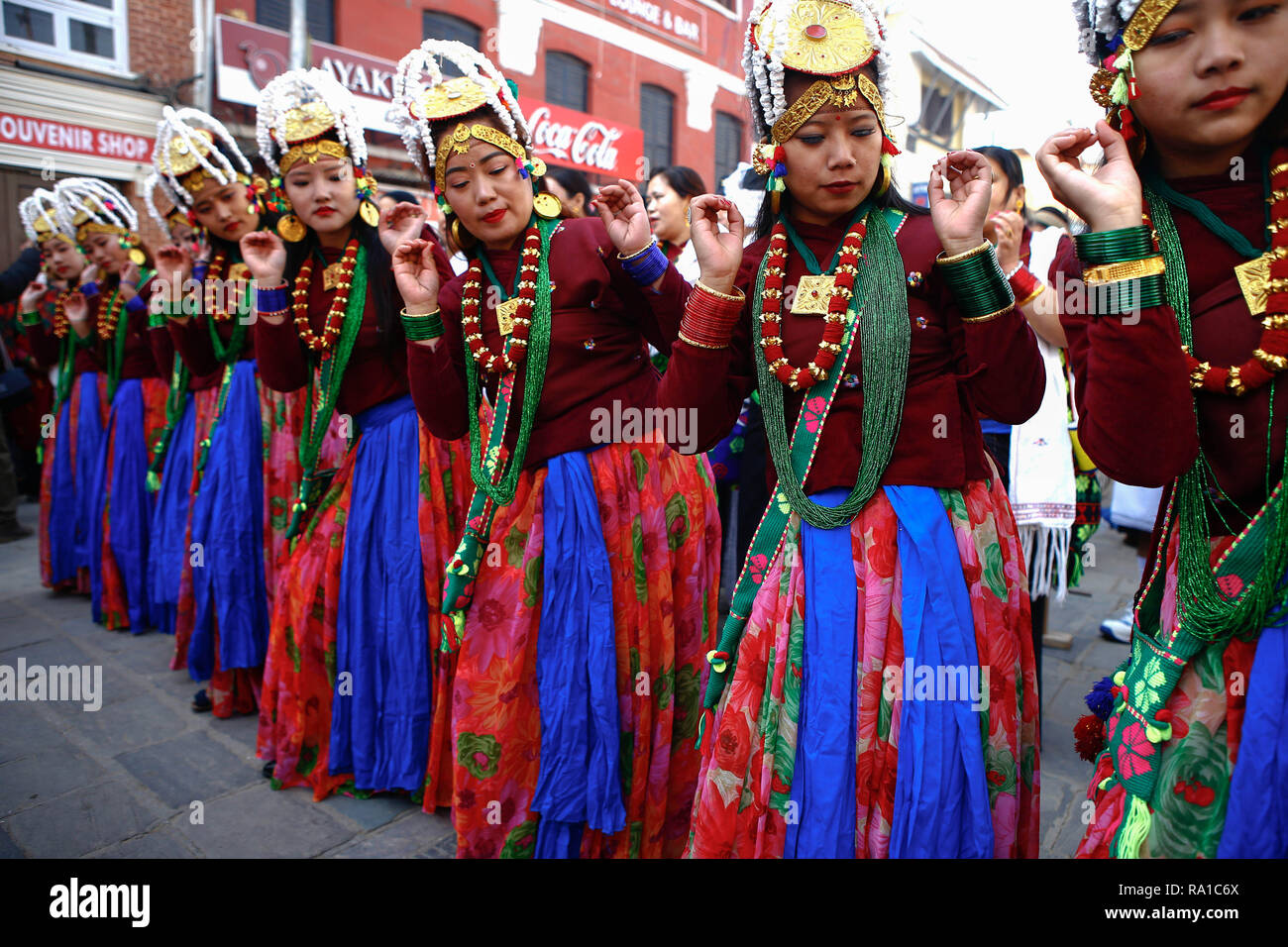Nepalese girls from ethnic Gurung community in traditional attire dance as they take part in parade to mark their New Year also known as Tamu Losar. The indigenous Gurungs, also known as Tamu, are celebrating the advent of the year of the deer. Stock Photo