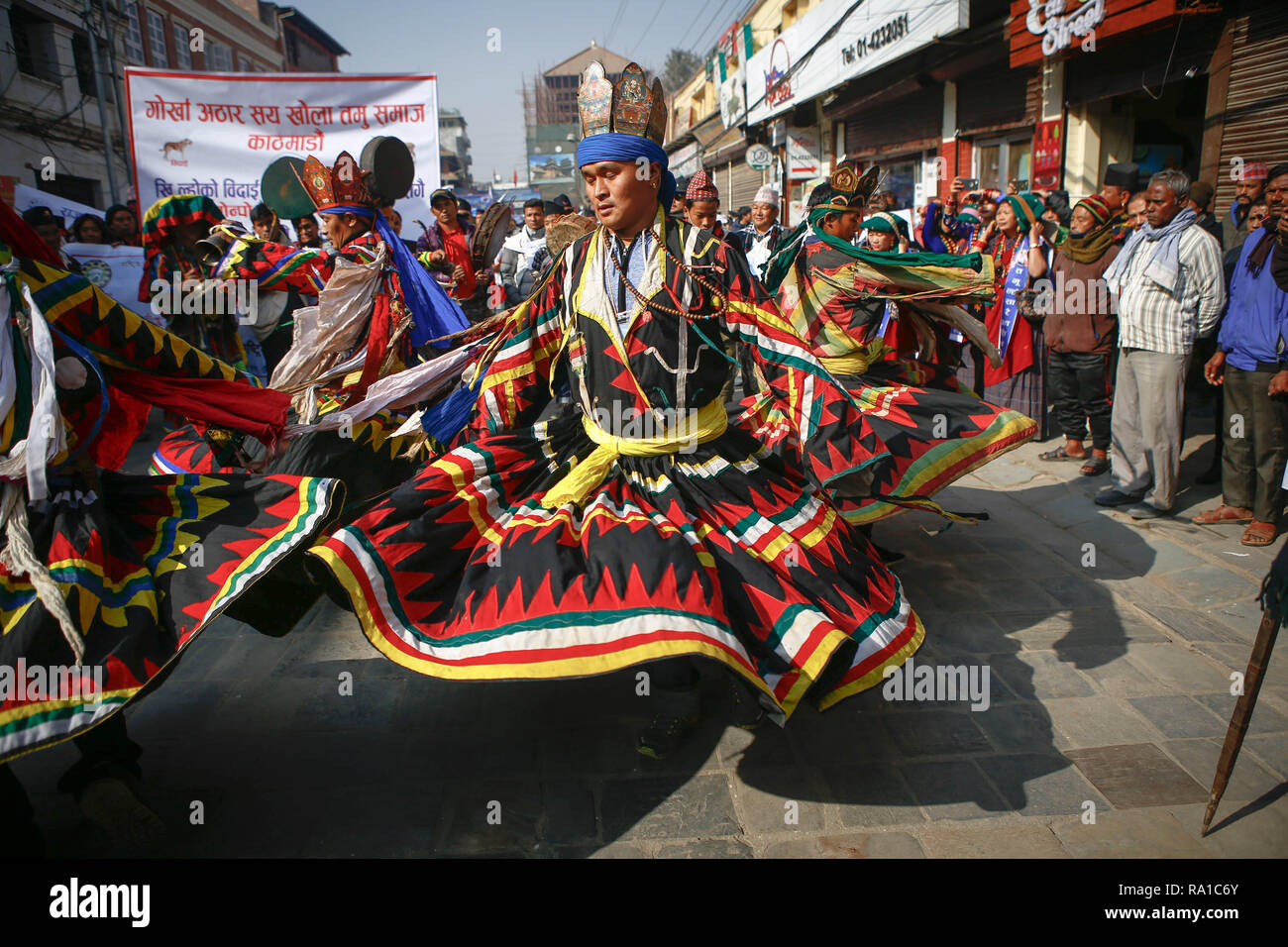 Nepalese men from ethnic Gurung community in traditional attire dance as they take part in parade to mark their New Year also known as Tamu Losar. The indigenous Gurungs, also known as Tamu, are celebrating the advent of the year of the deer. Stock Photo