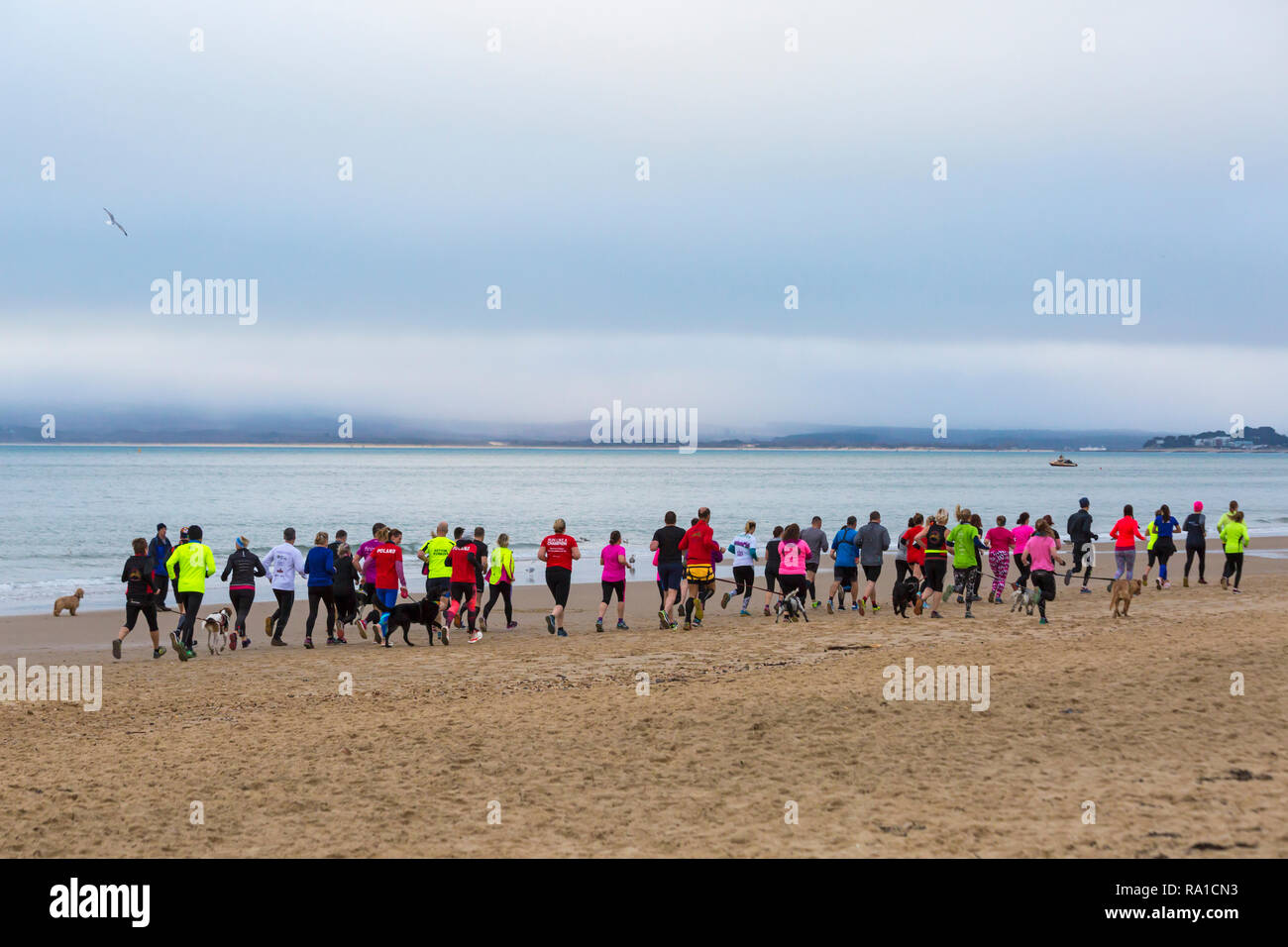 Bournemouth Dorset UK. 30th December 2018. Participants take part in the Beach Race Race the Tide a low tide beach run along the beautiful shoreline of Bournemouth beach towards Sandbanks beach. Runne...