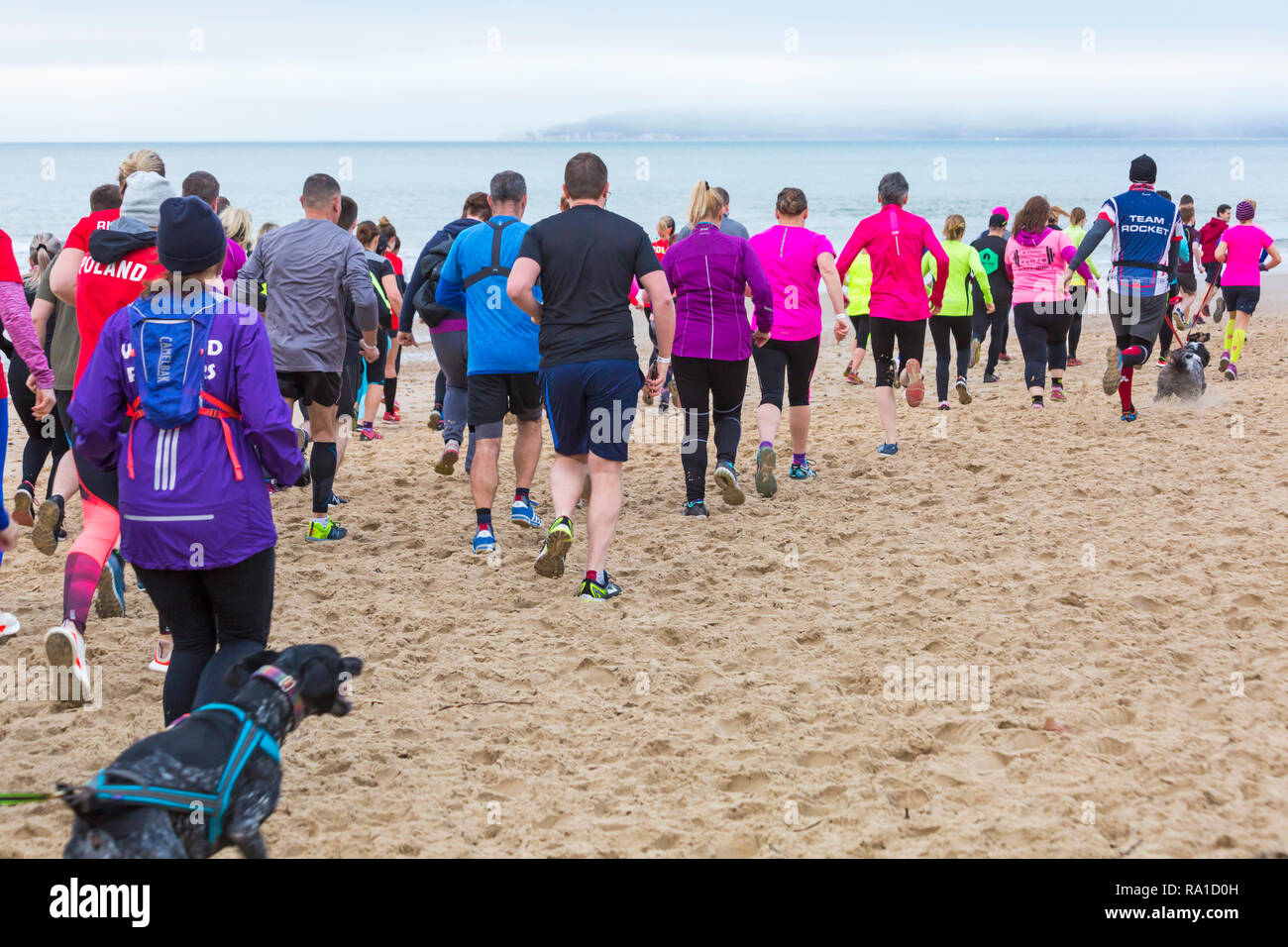 Bournemouth, Dorset, UK. 30th December 2018. Participants take part in the Beach Race, Race the Tide, a low tide beach run along the beautiful shoreline of Bournemouth beach towards Sandbanks beach. Runners run the 5k or 10k race along the seashore and over the groynes before the tide comes in - good exercise after the excesses of Christmas! Credit: Carolyn Jenkins/Alamy Live News Stock Photo