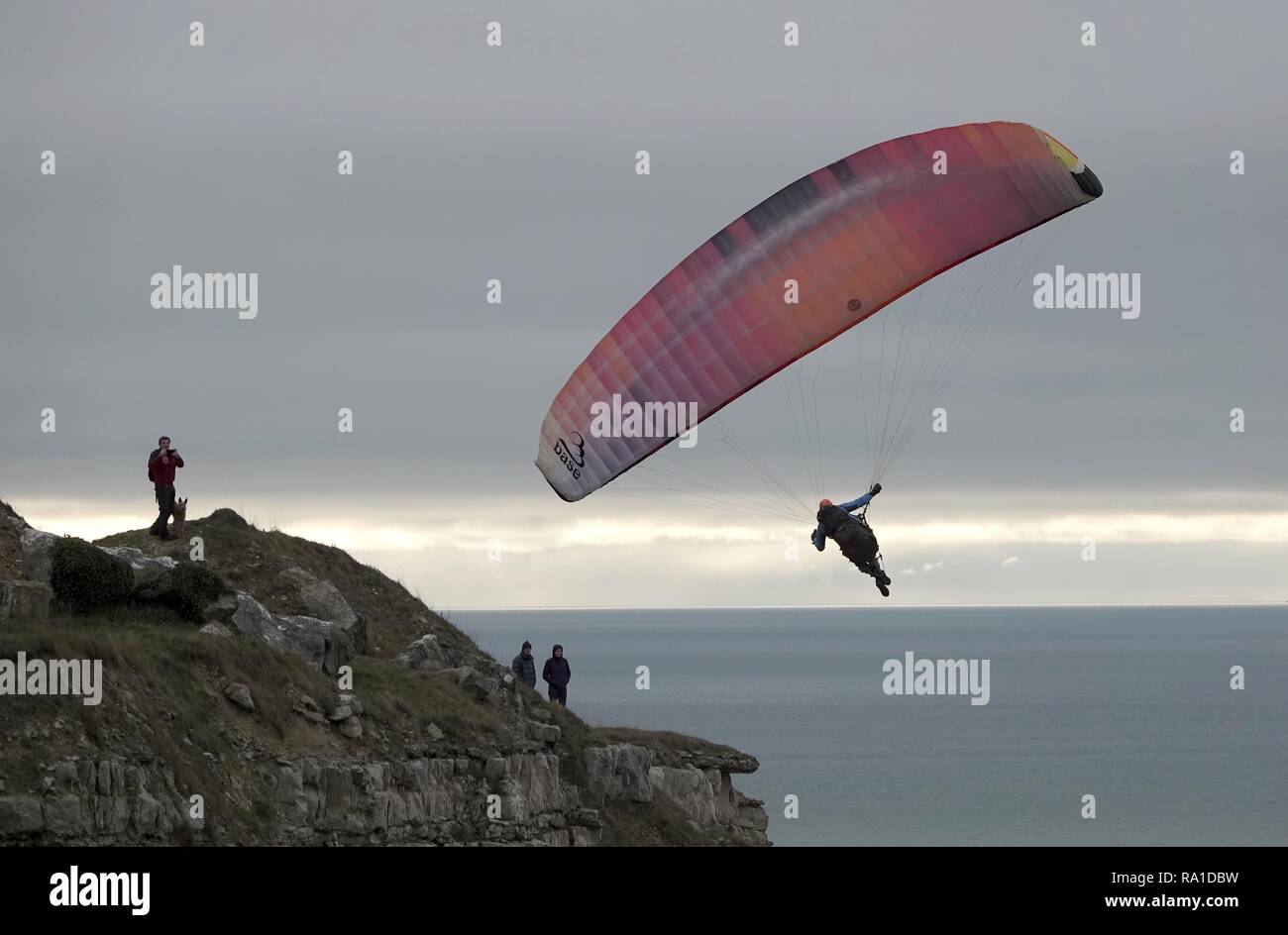 Portland, Dorset, UK. 30th December 2018. Paraglider at Chesil Beach, Portland, Dorset Credit: Finnbarr Webster/Alamy Live News Stock Photo