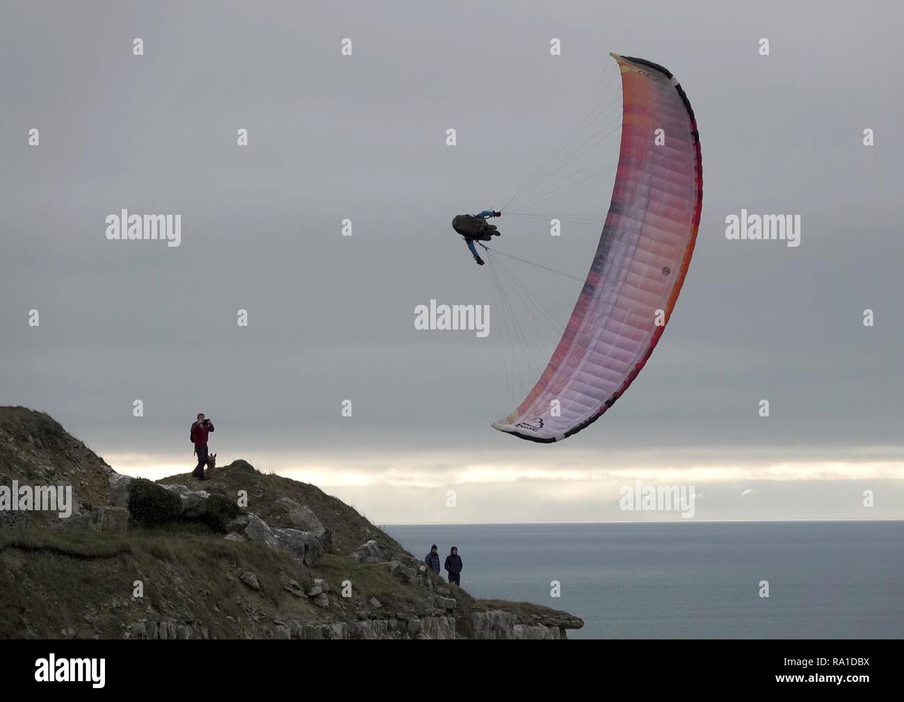 Portland, Dorset, UK. 30th December 2018. Paraglider at Chesil Beach, Portland, Dorset Credit: Finnbarr Webster/Alamy Live News Stock Photo