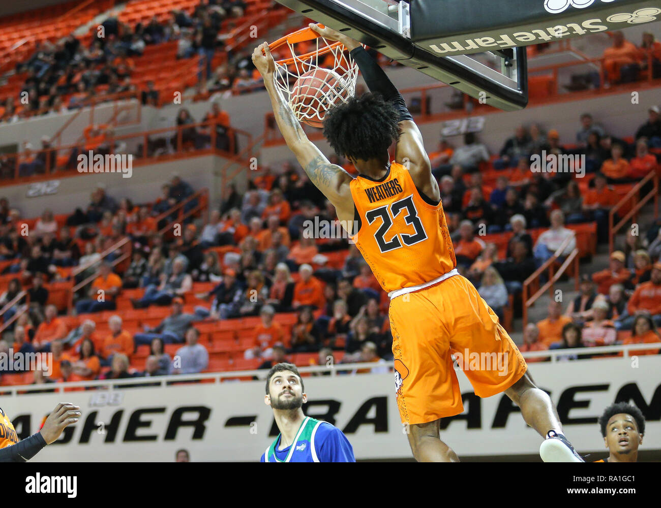 Stillwater, USA. 29th Dec, 2018. Oklahoma State Guard Michael Weathers (23) dunks the ball during a basketball game between the Texas A&M University-Corpus Christi Islanders and Oklahoma State Cowboys at Gallagher-Iba Arena in Stillwater, OK. Gray Siegel/CSM/Alamy Live News Stock Photo