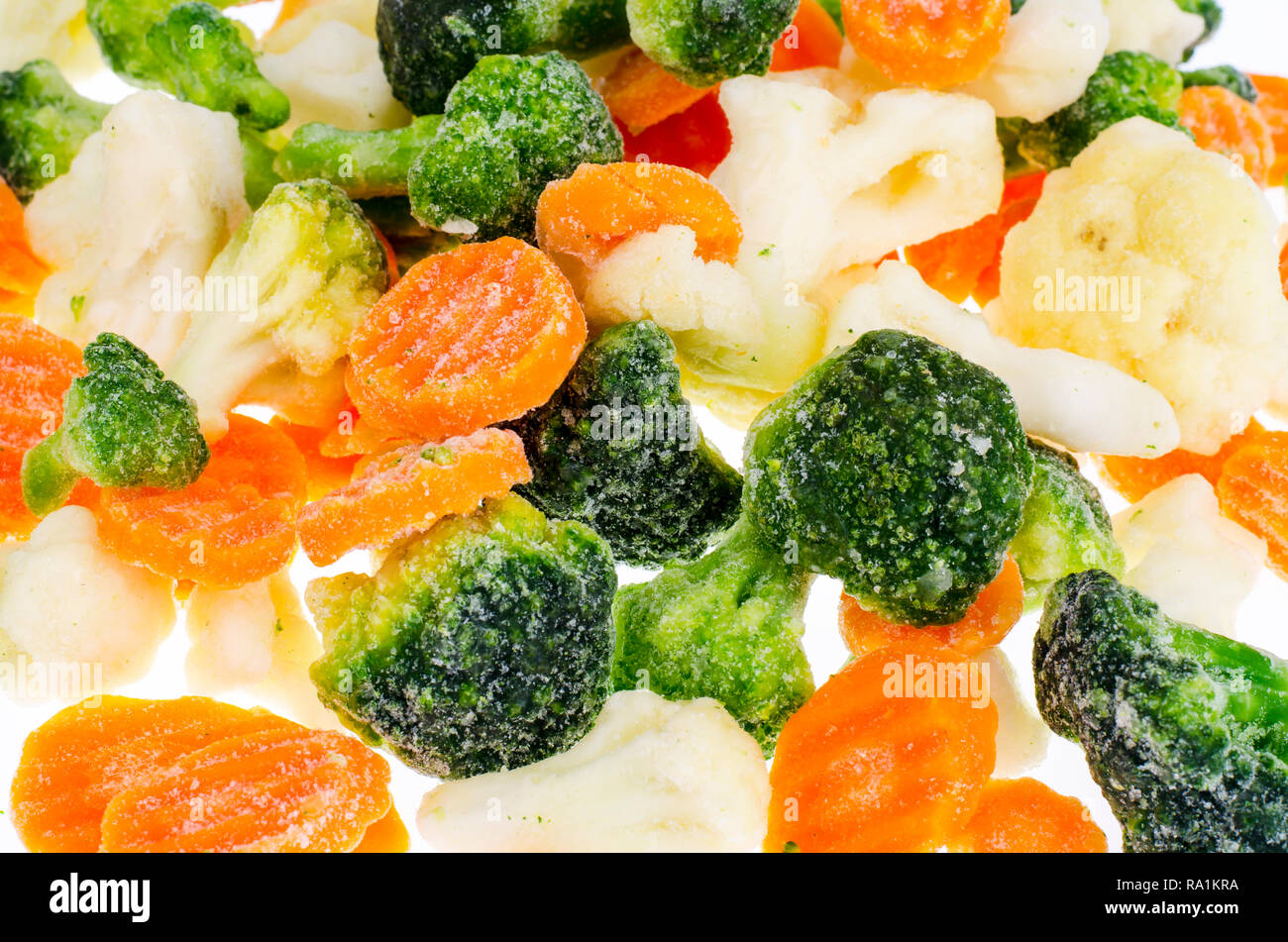 Frozen broccoli, cauliflower, carrots on white background. Studio Photo