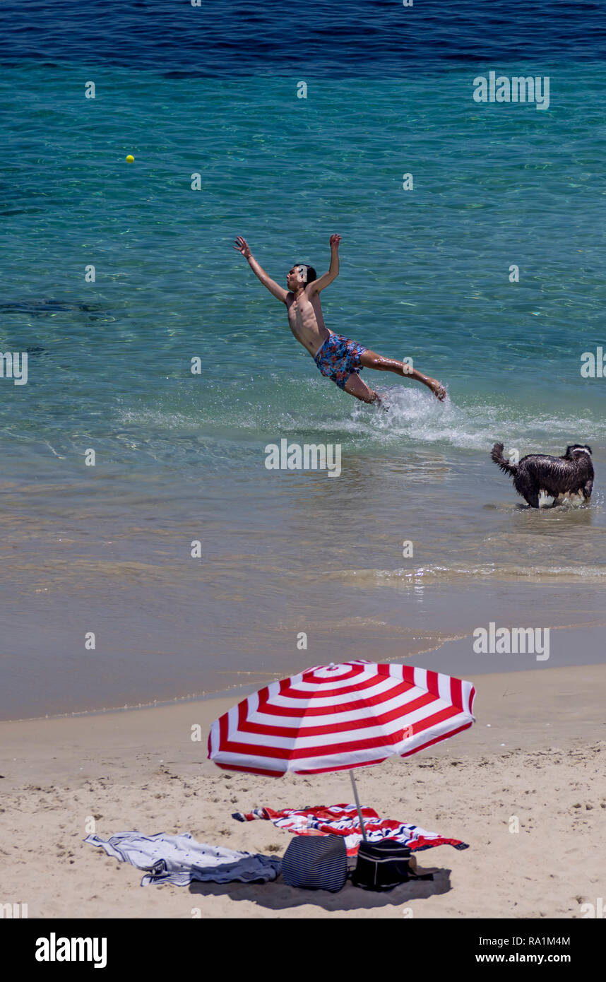 Boy catching a ball in the water at Cottesloe Beach,, Western Australia Stock Photo