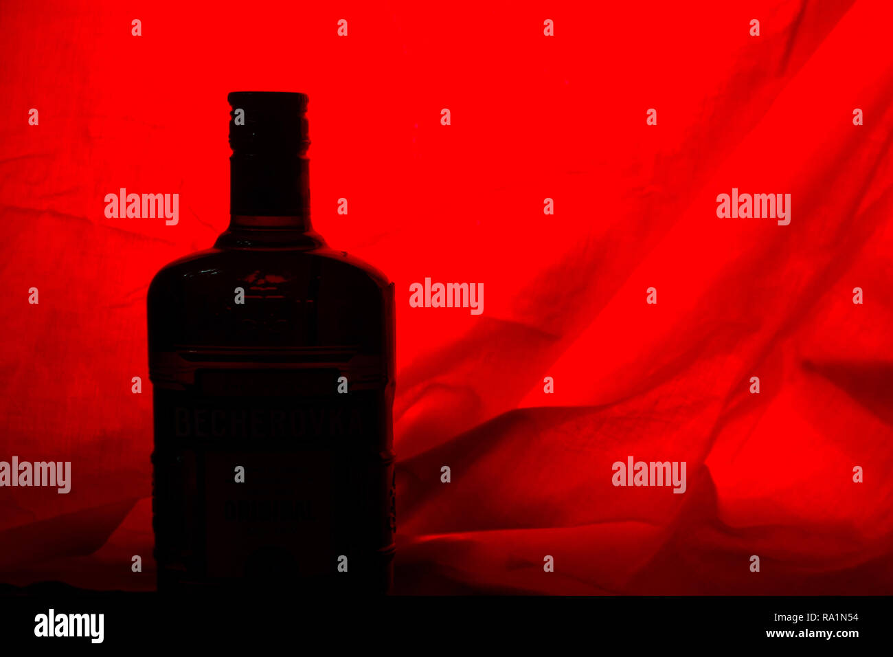 alcohol bottle on red backround. copy cpace Stock Photo