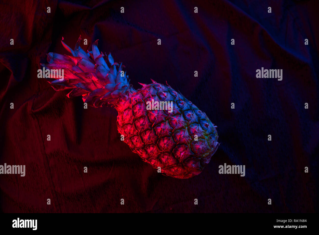 Pineapple in dark neon color on blackbackground Stock Photo - Alamy