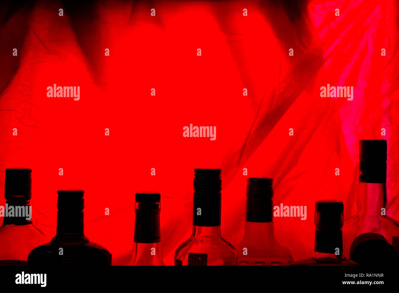 alcohol bottle on red backround. copy cpace Stock Photo