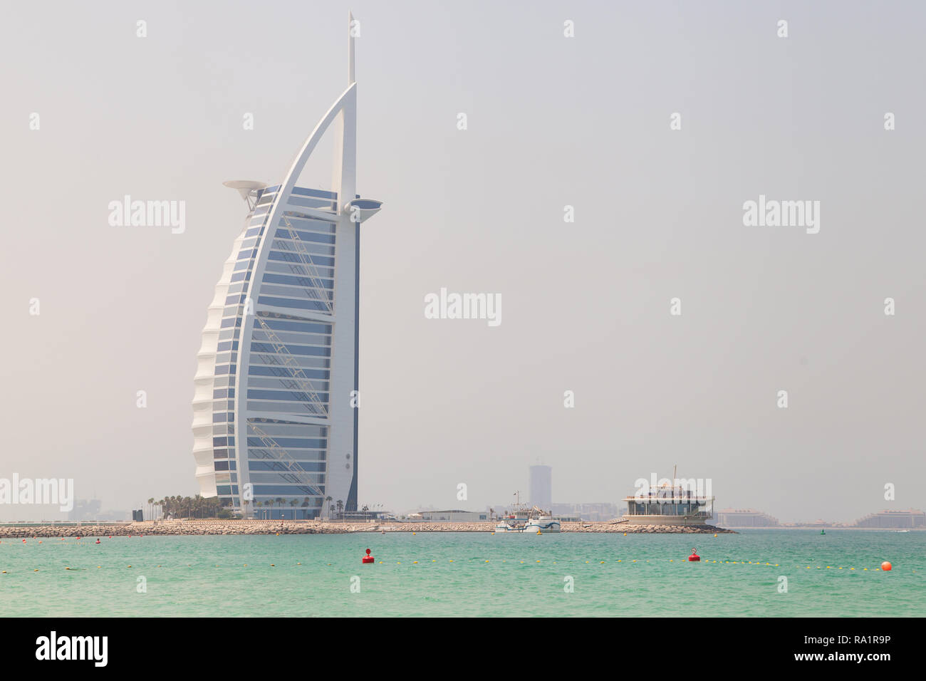 Dubai, United Arab Emirates - September 8, 2018: Burj Al Arab seen from the Jumeirah Beach on a misty day in Dubai, United Arab Emirates. Stock Photo