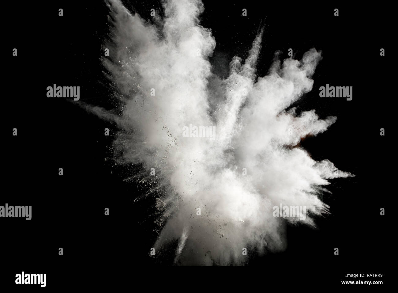 White powder explosion on black background.Stopping the movement of white powder on dark background. Stock Photo