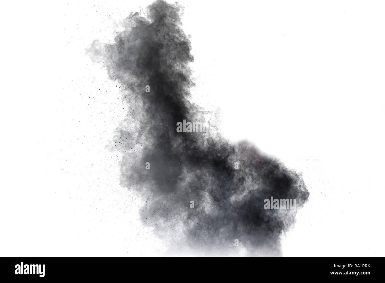 Black powder explosion against white background.The particles of charcoal splattered on white background. Closeup of black dust particles explode isol Stock Photo