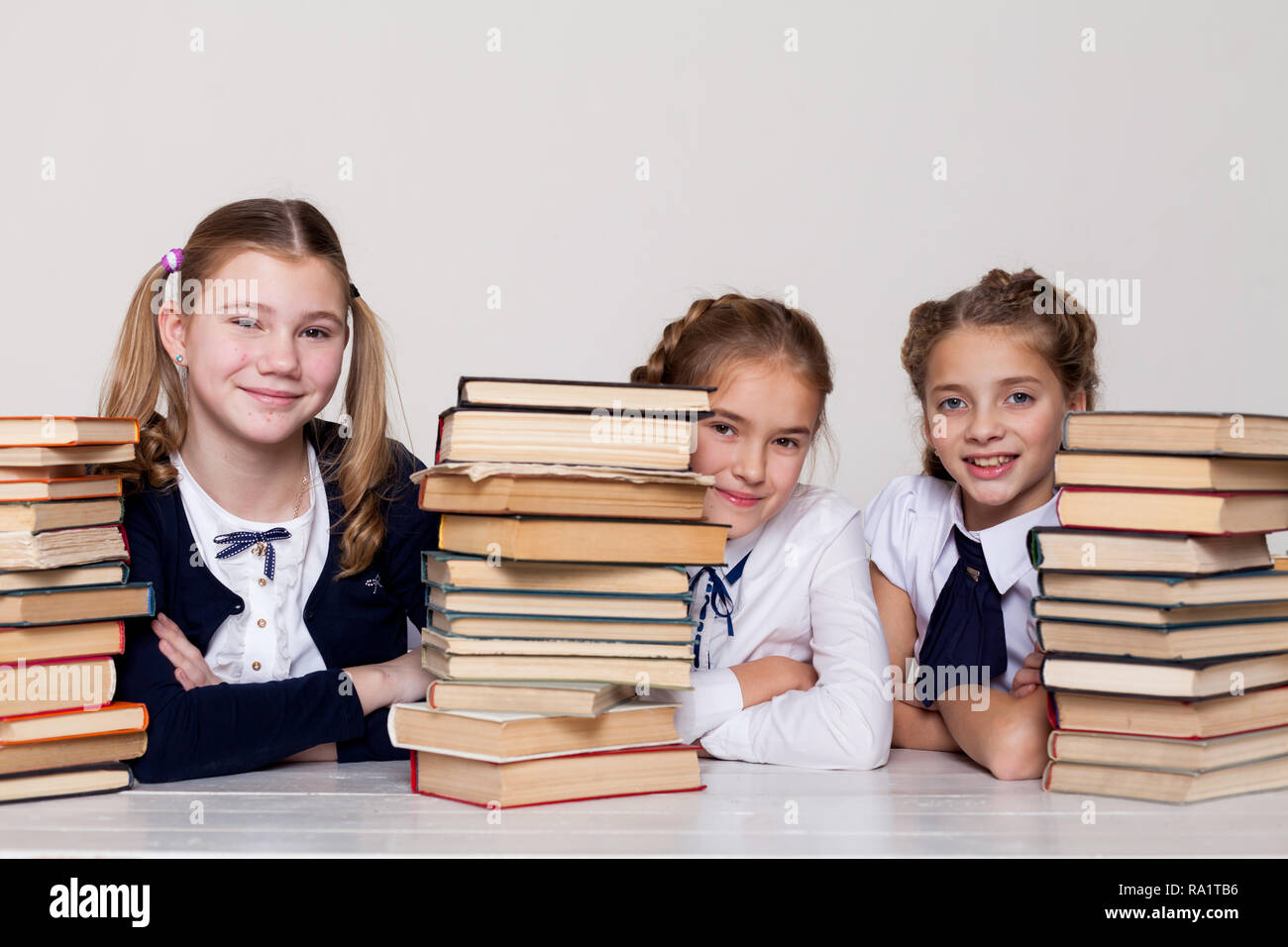 two girls schoolgirls sit with books at his desk on the lesson at ...