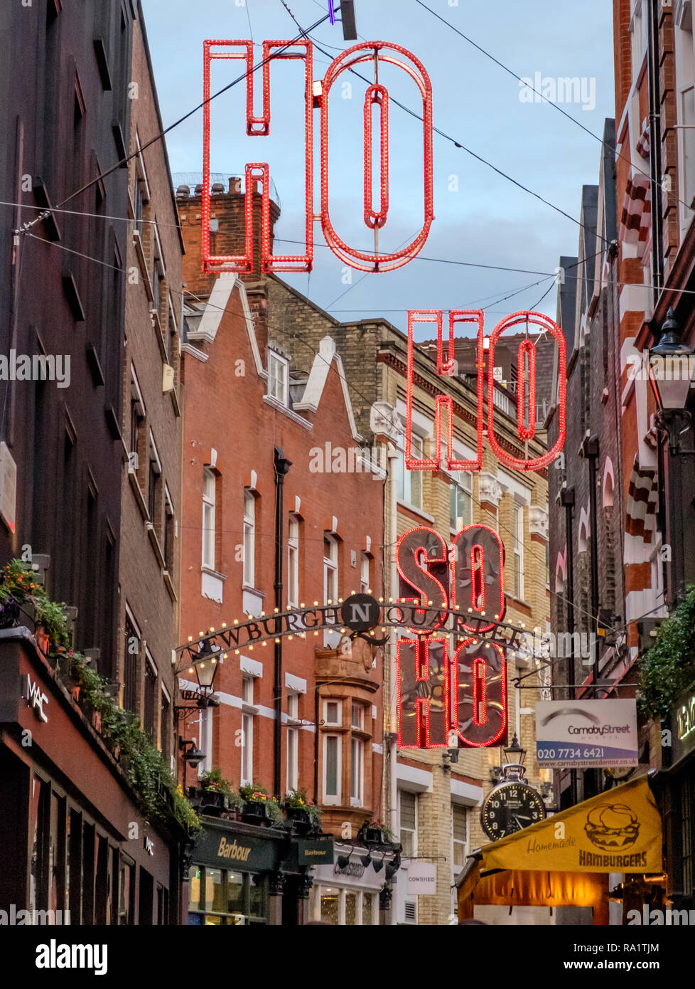 Carnaby Street London with Christmas lights, Dec. 2018. Ho ho Soho written in red neon lights. Stock Photo