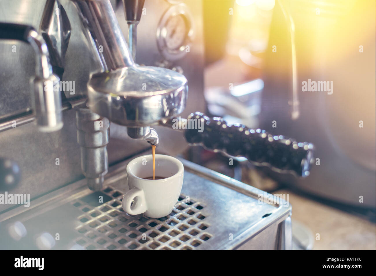 Proffessional brewing - coffee bar details. Espresso coffee pouring from espresso machine. Stock Photo