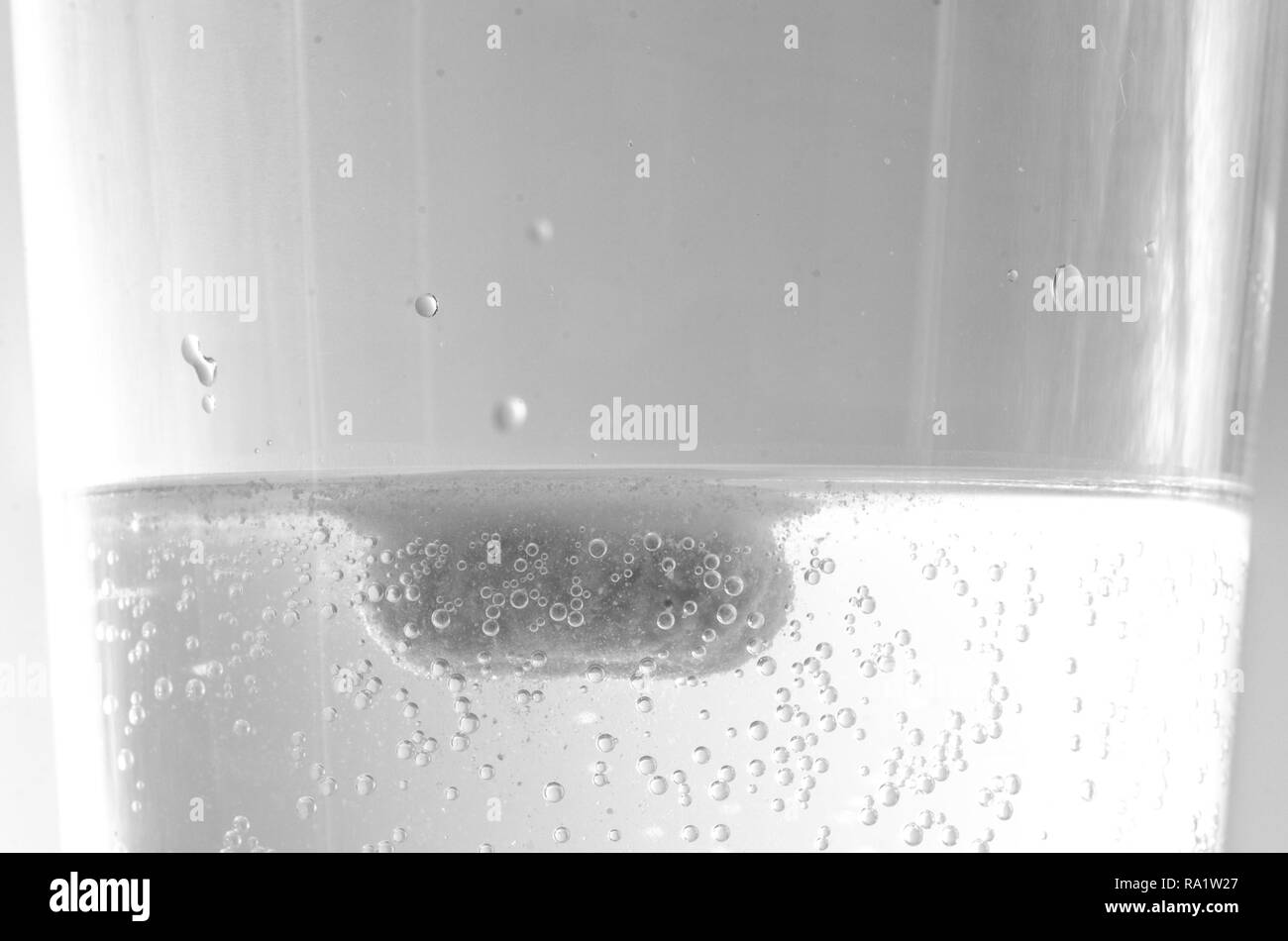 Effervescent tablet dissolving in water Black and White Stock Photos