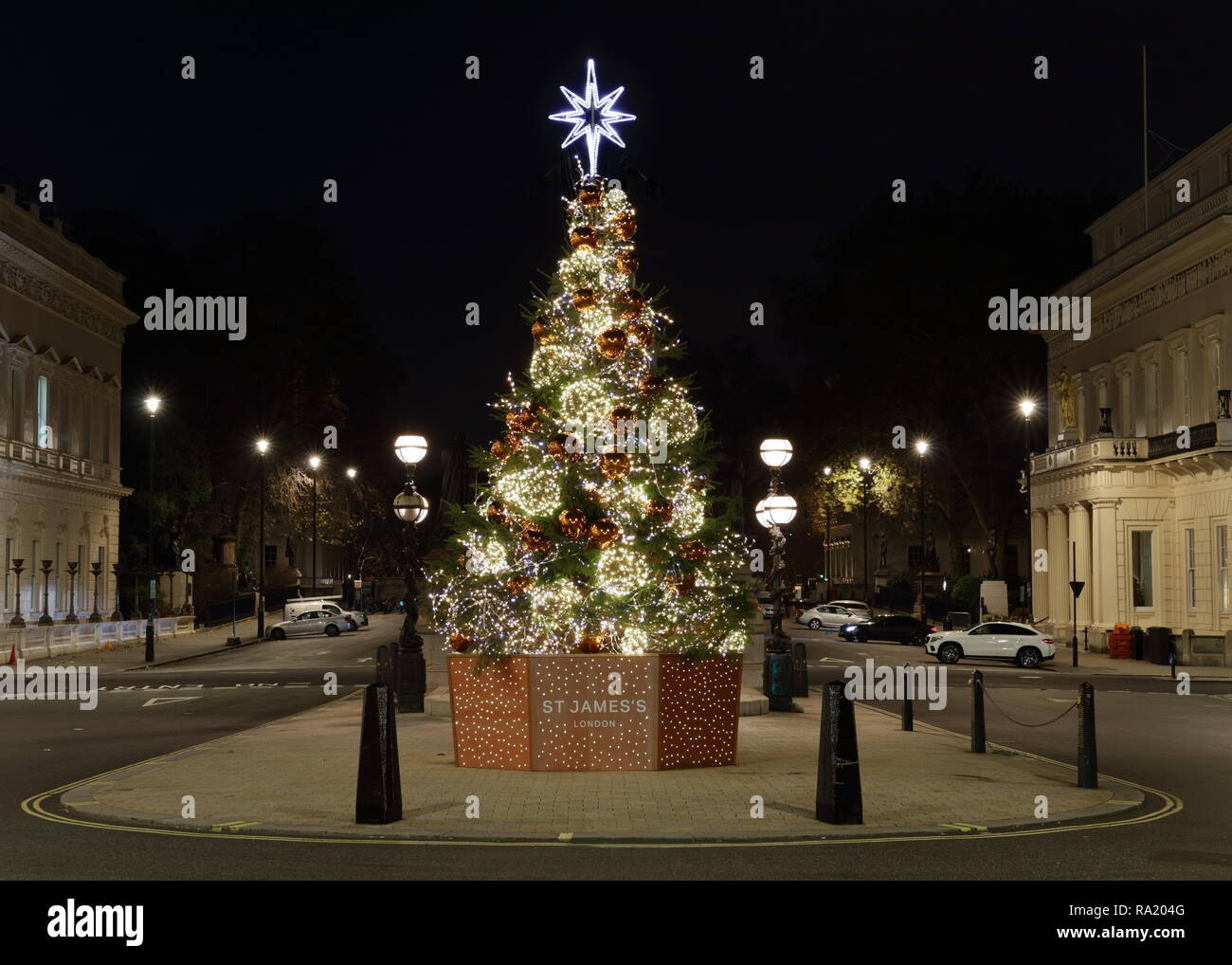 Christmas tree in Waterloo Place in London, Late night with empty street and lots of Christmas lights around. Stock Photo