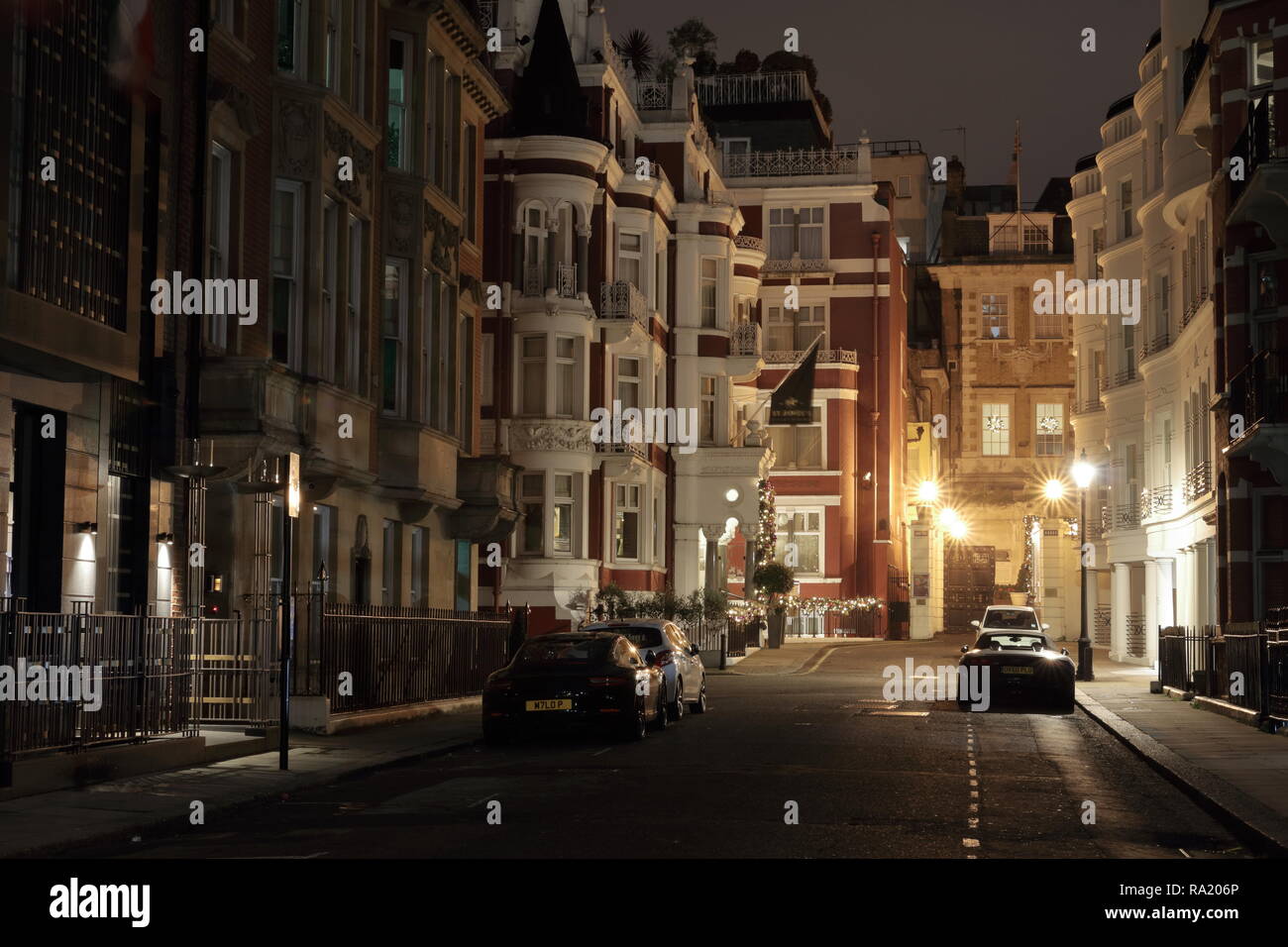 St. James Hotel and Club facade. Picture taken in London, Park Place at night. Few expensive cars park at this street.  Mayfair London Stock Photo