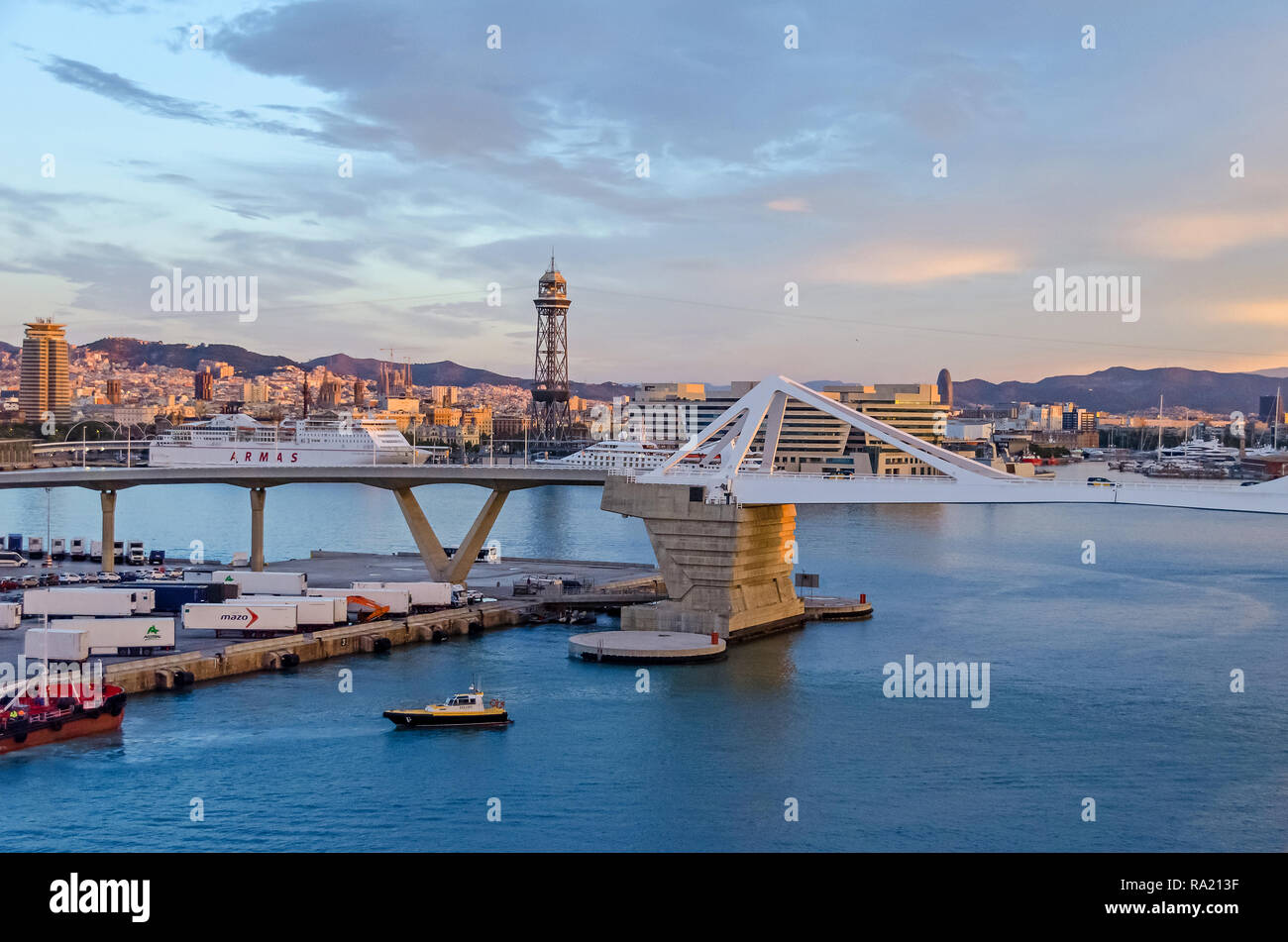 Barcelona, Spain - November 10, 2018: Port Vell with its bascule bridge Porta d'Europa, containers of the Moll Ponent, a tower  of the aerial tramway Stock Photo