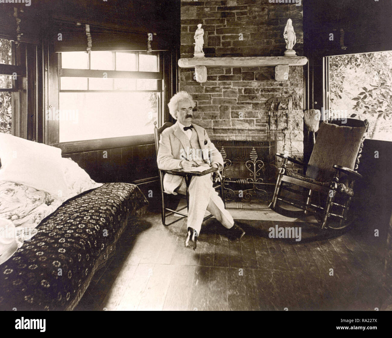 Mark Twain seated in bedroom Stock Photo