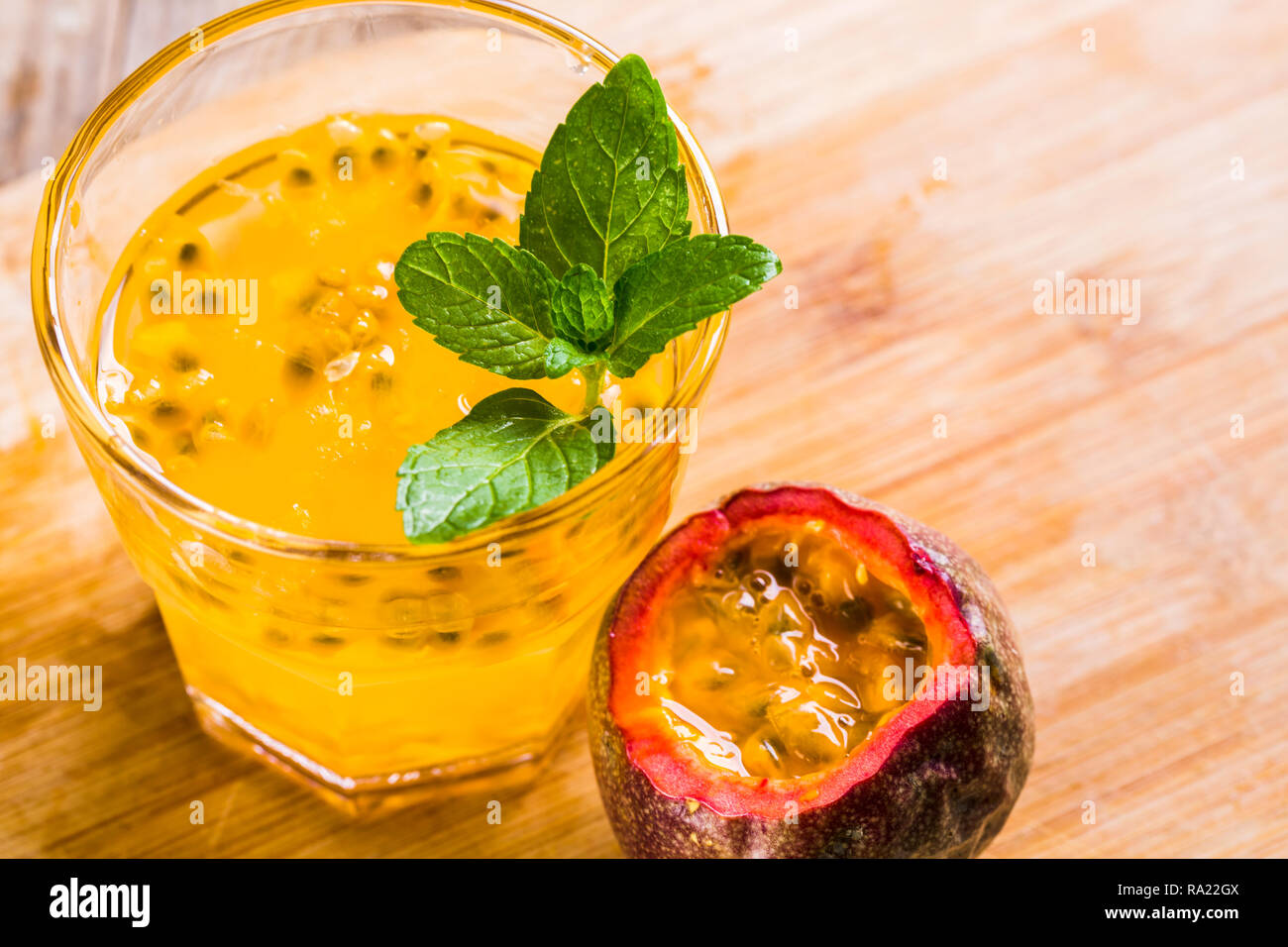 Glass of fresh passion fruit mint on table Stock Photo