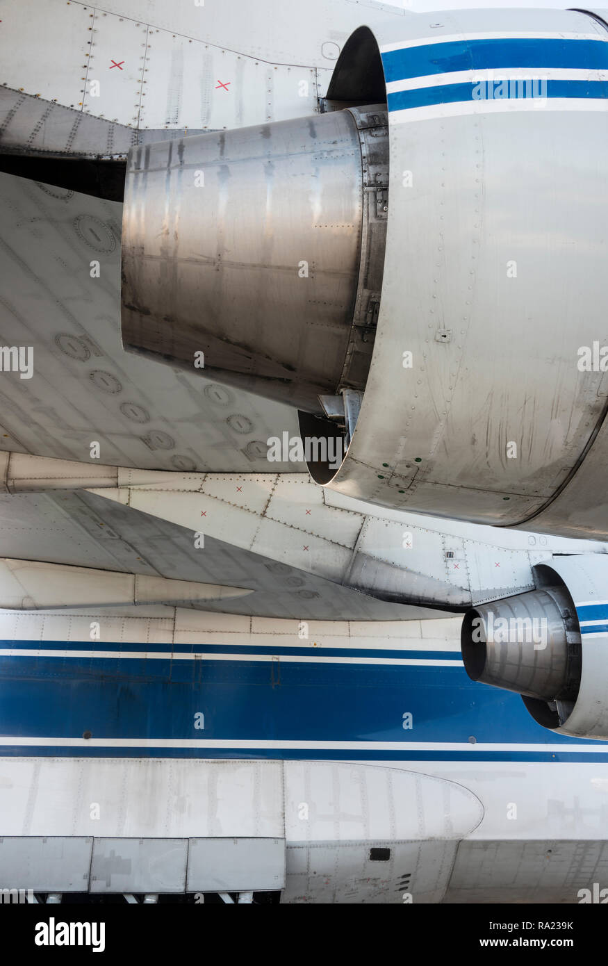 Detail of engines and wing of a modern military cargo jet, white with ...