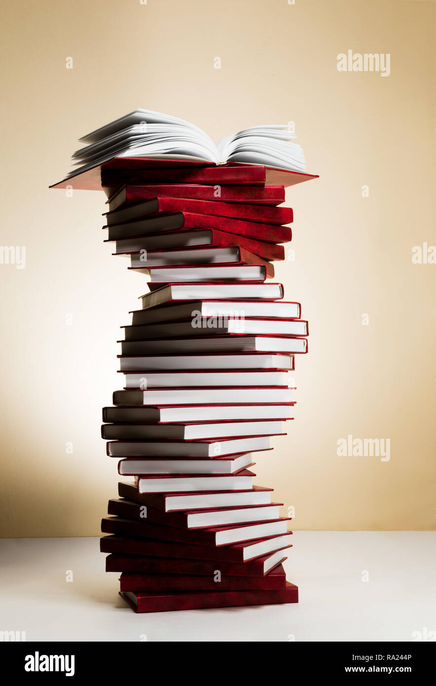 A spiral of stacks of books in the form of DNA and an open textbook at ...