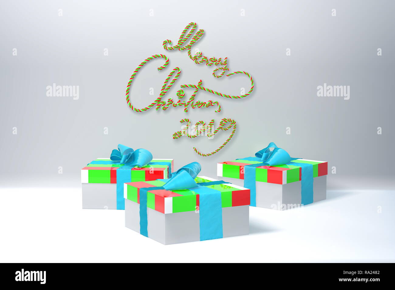 Merry Christmas 2019 lettering written by green and red spripe on white wall and three colorful present gift boxes with bows beside. 3d illustration Stock Photo