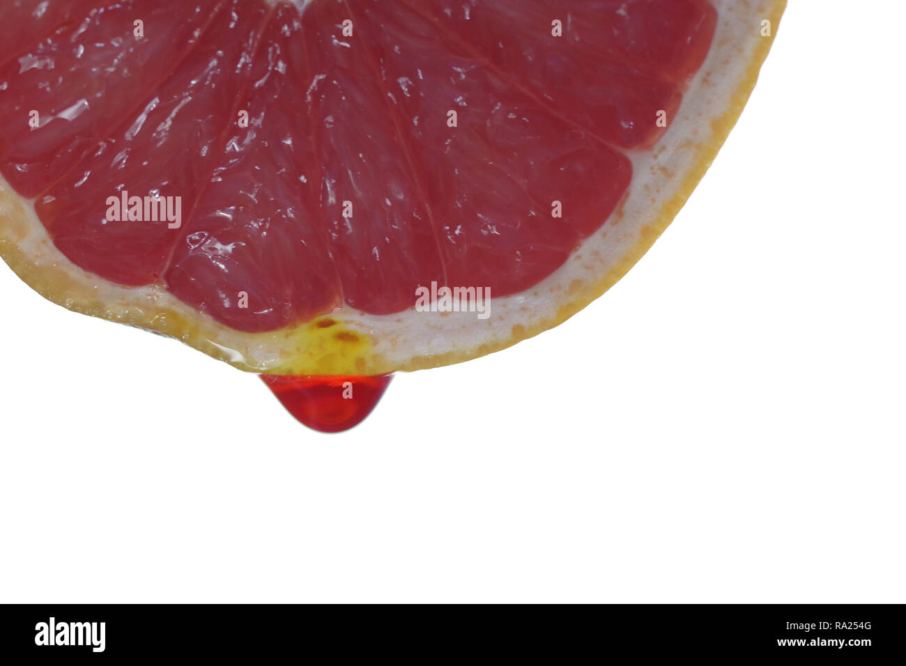 grapefruit with dripping clear juice on white background Stock Photo