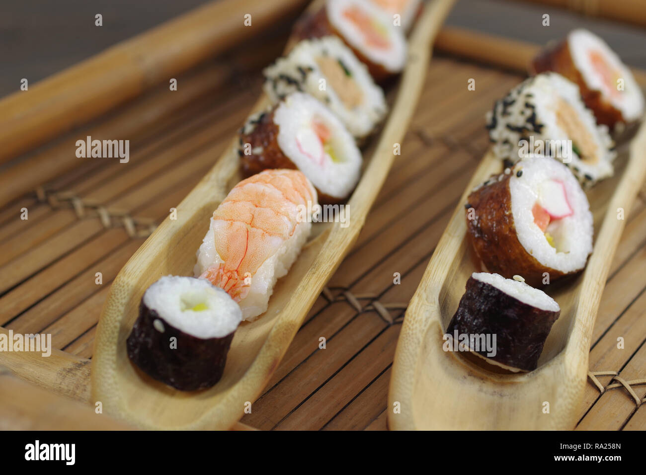 portion sushi and wooden hopsticks on plate Stock Photo