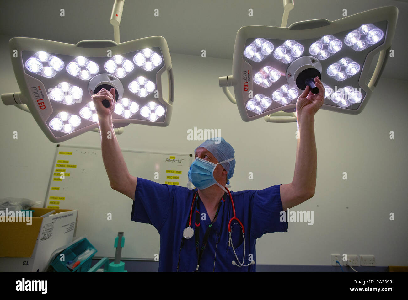 A hospital technician prepares the theatre for an operation hires