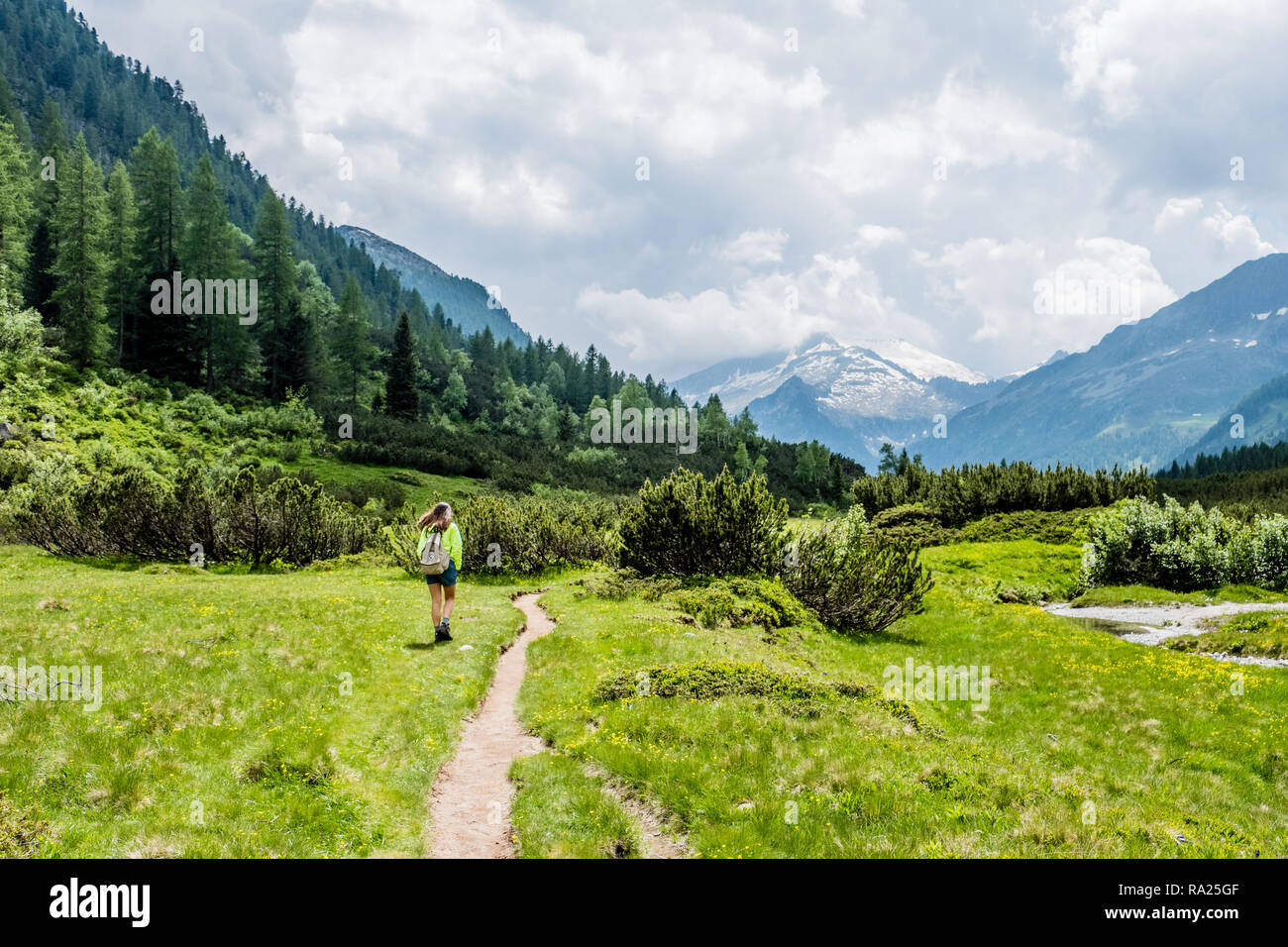 girl hiking in an alpine valley Stock Photo