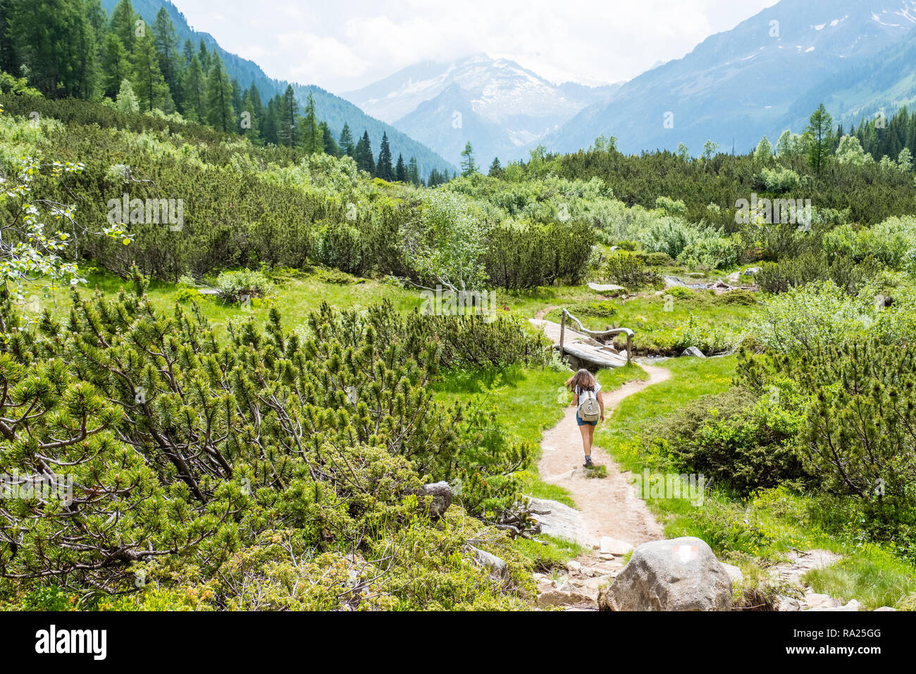 girl hiking in an alpine valley Stock Photo
