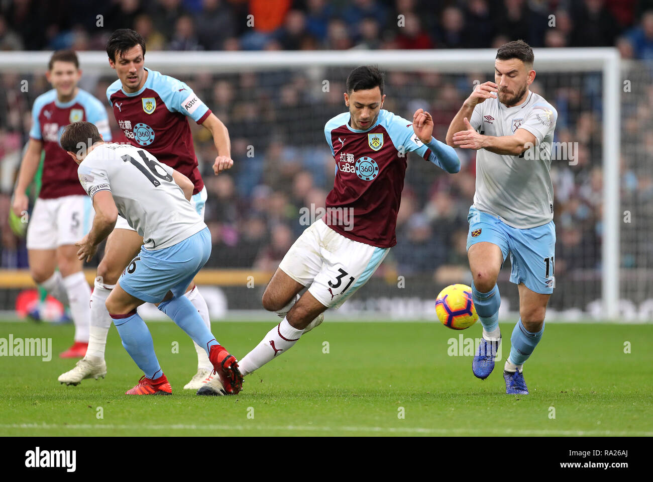 Burnley's Dwight McNeil (centre) and West Ham United's Robert Snodgrass (right) battle for the ball during the Premier League match at Turf Moor, Burnley. Stock Photo