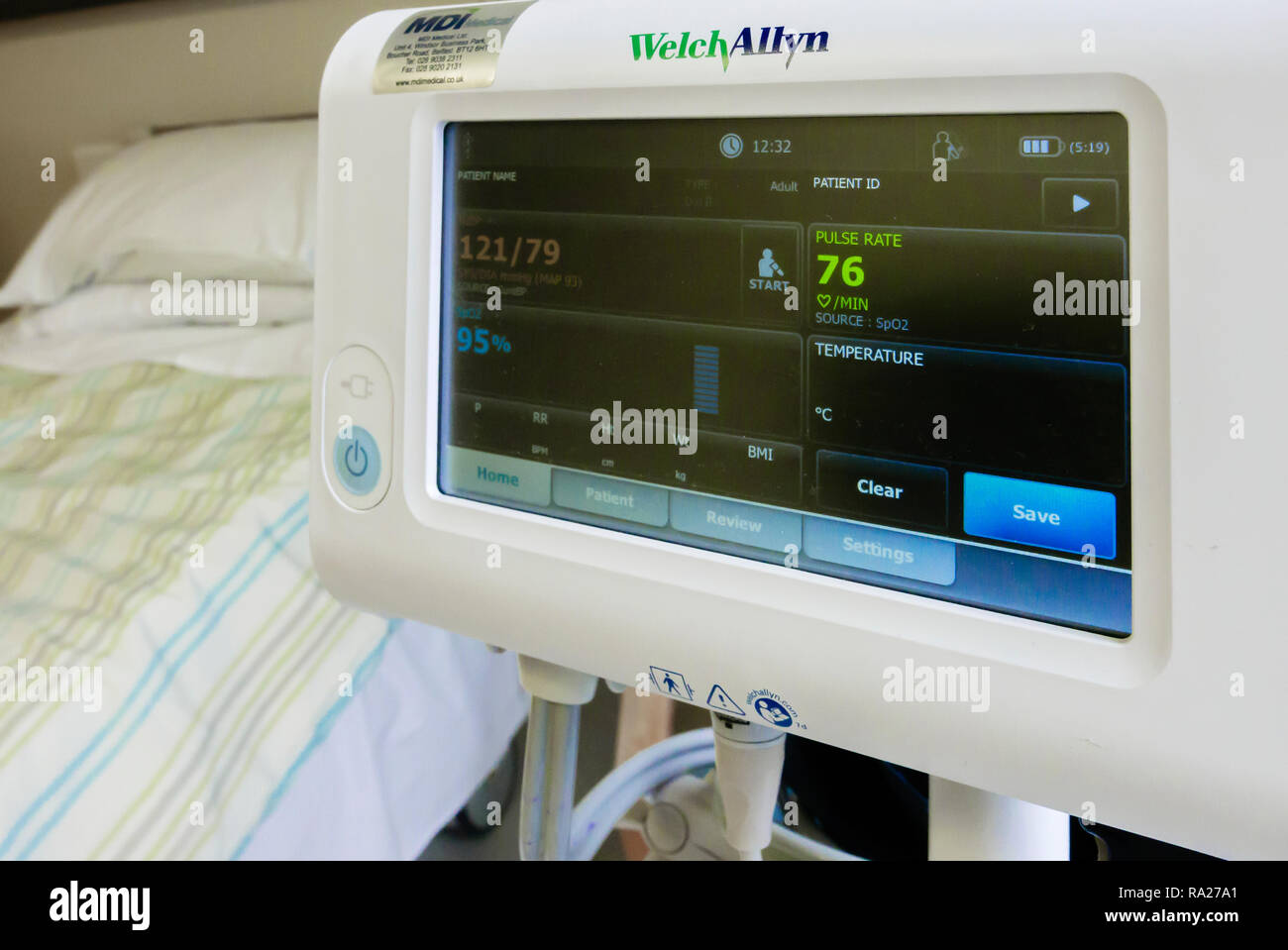 WelchAllyn blood pressure monitor in a hospital ward showing a normal blood pressure of 121/79, and a blood saturation level of 95%. Stock Photo