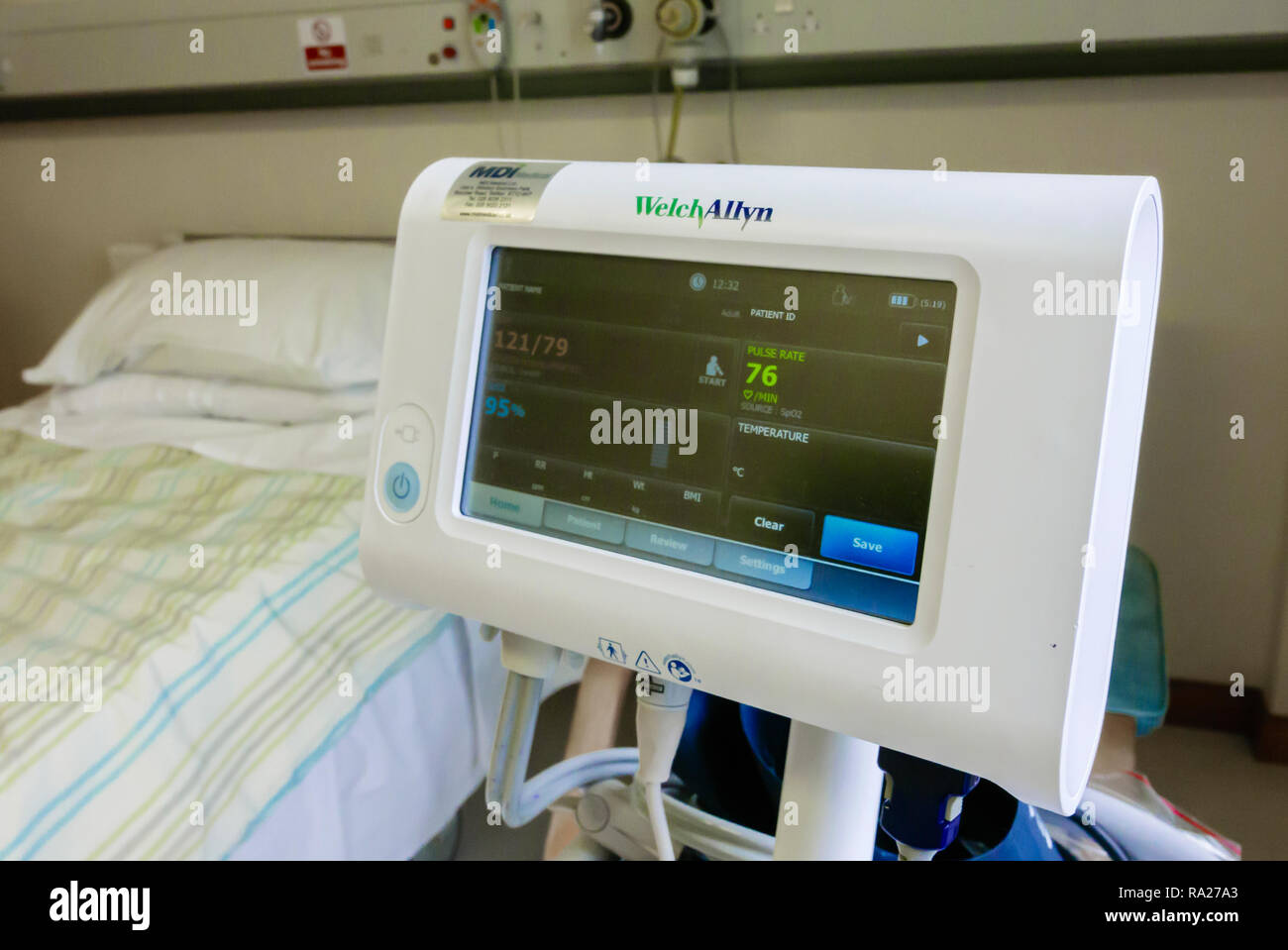 WelchAllyn blood pressure monitor in a hospital ward showing a normal blood pressure of 121/79, and a blood saturation level of 95%. Stock Photo