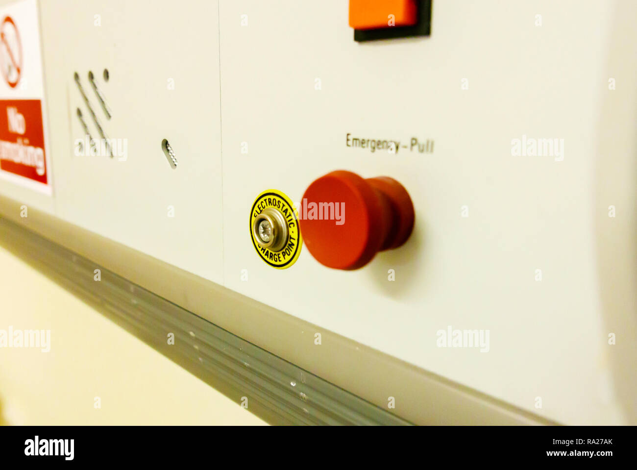 Bed head unit in a hospital ward showing an emergency red pull call bell and an electrostatic discharge point. Stock Photo