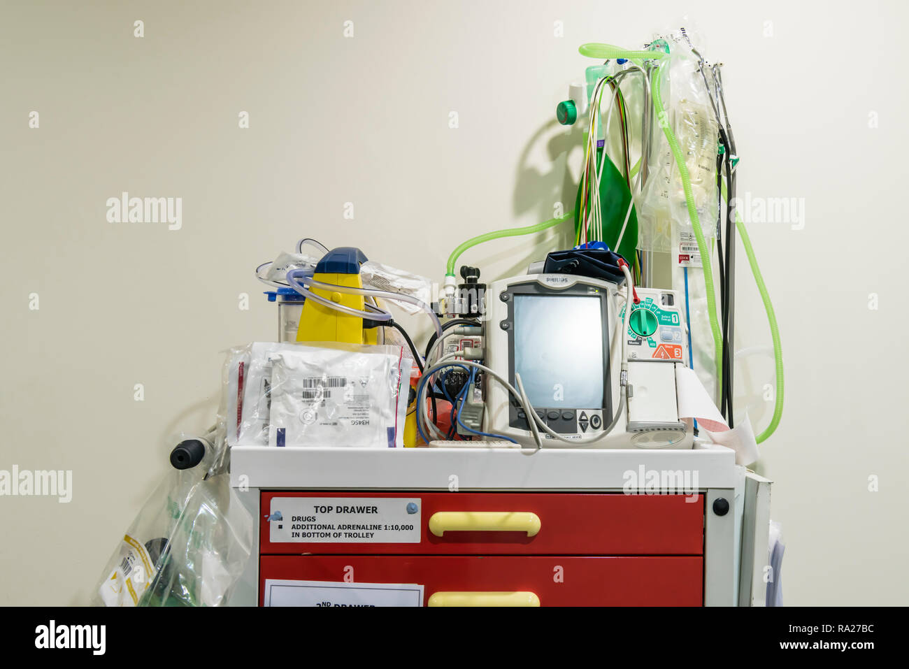Hospital crash trolley for emergency resuscitation with a electrocardiograph ECG and a defibrillator along with emergency fluids etc. Stock Photo