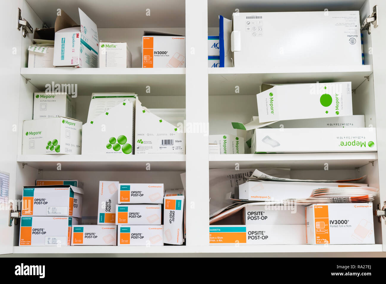 Cupboard in a hospital treatment room containing dressings including Opsite and Mepore post-surgical dressings Stock Photo
