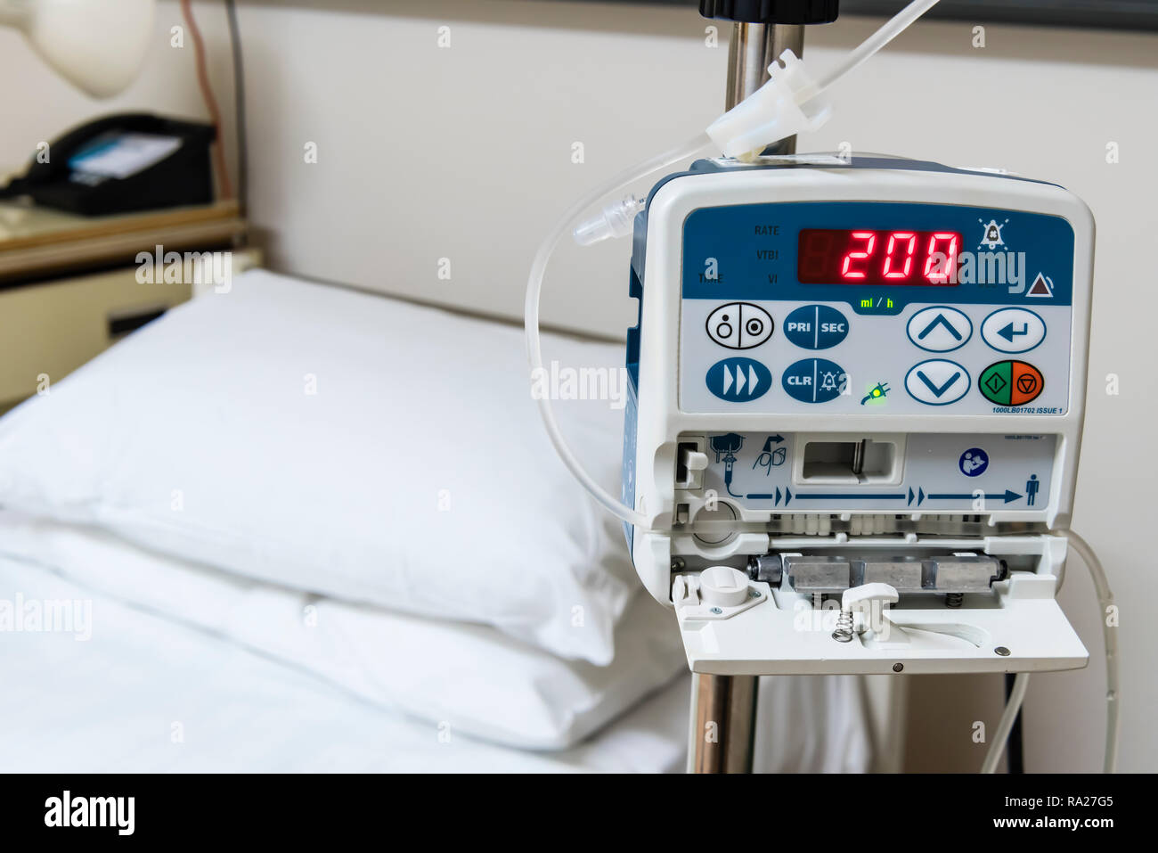Drip infusion pump in a hospital ward, used to deliver controlled doses of fluids and medicines. Stock Photo