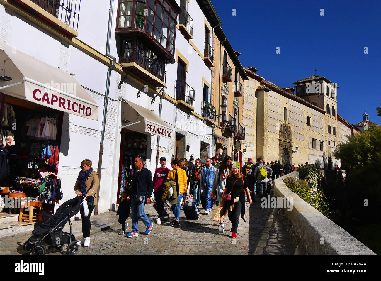 Tourists stroll along Carrera del Darro near the Alhambra in Granada, Spain. Stock Photo