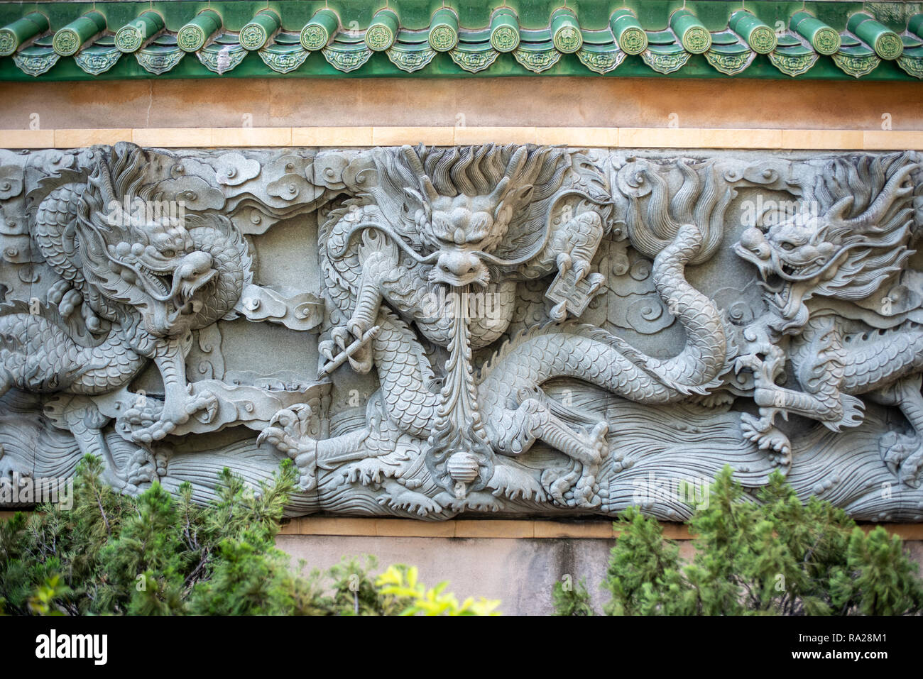 Three of the nine dragons adorning the rear wall of Yau Ma Tei Tin Hau Temple overlooking the Public Square Street Rest Garden in Hong Kong. Stock Photo